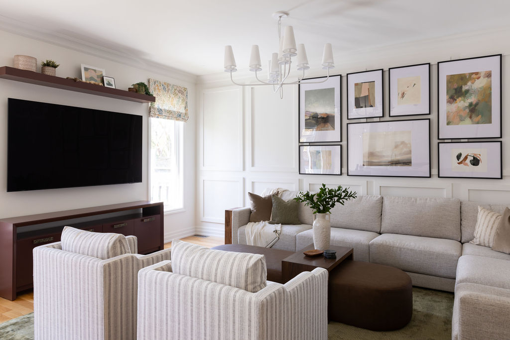 sitting area, large custom ottoman, custom furniture, oxblood, matte white lighting, striped chairs, floating shelf, gallery wall