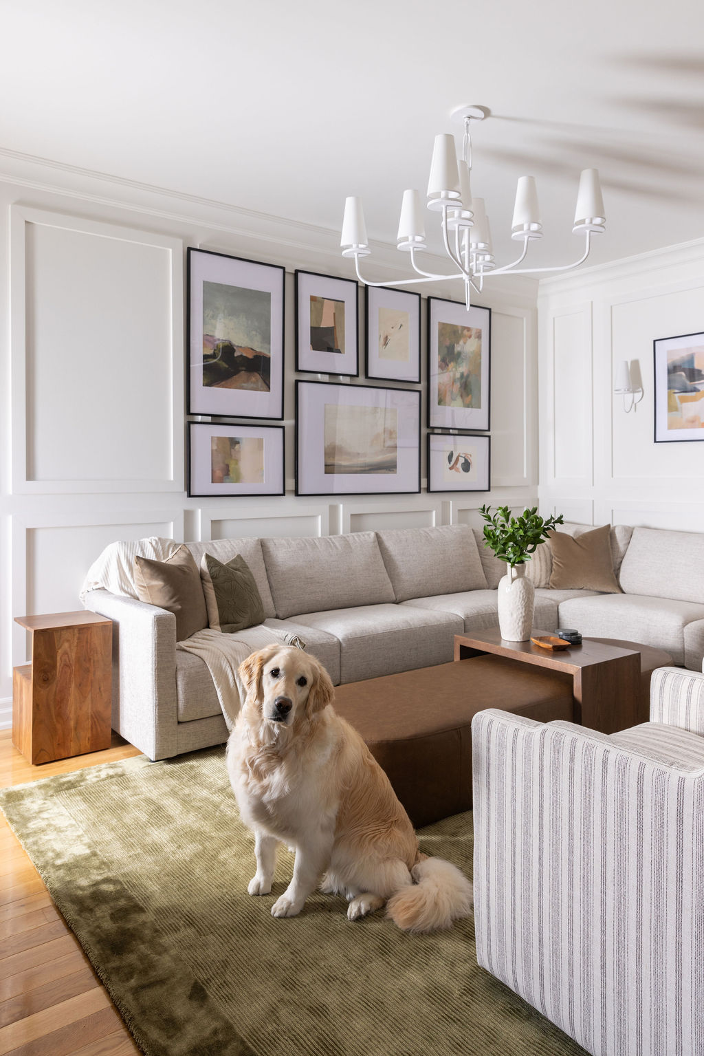 dog friendly design, green rug, olive rug, custom ottoman, striped armchair, custom gallery wall, unique matte white lighting, living room light fixture
