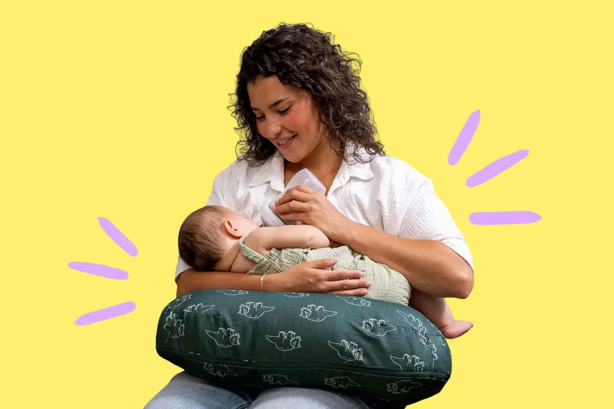 Mom nursing her baby with boppy breastfeeding pillow.