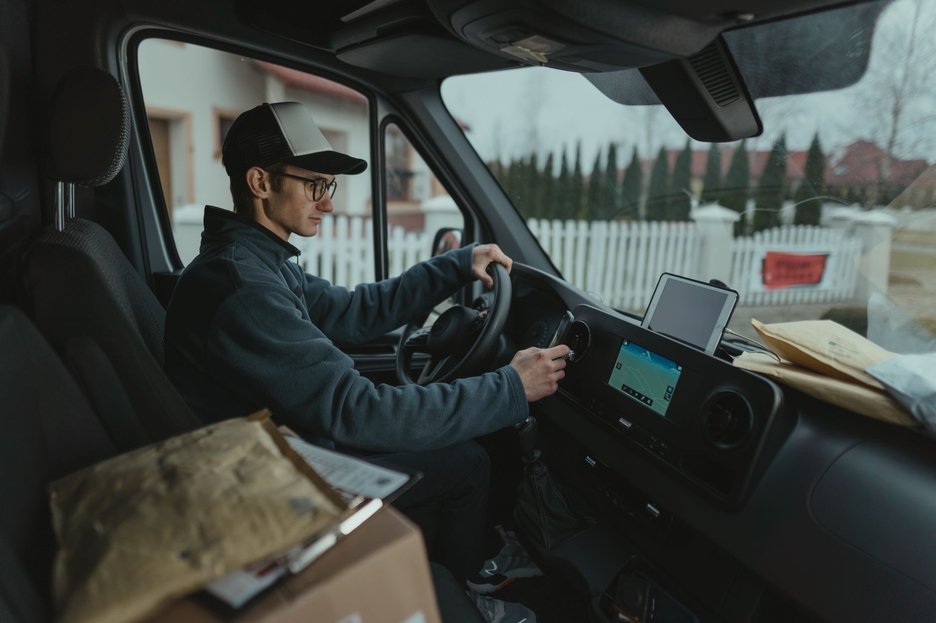 Delivery driver checking the route on a tablet in the cab