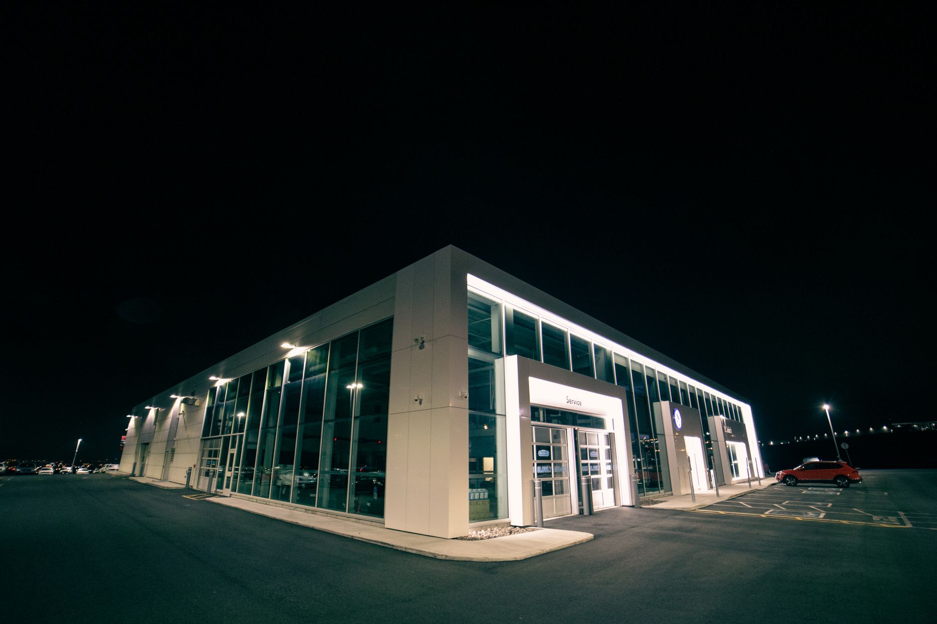 Car dealership building lit up at night