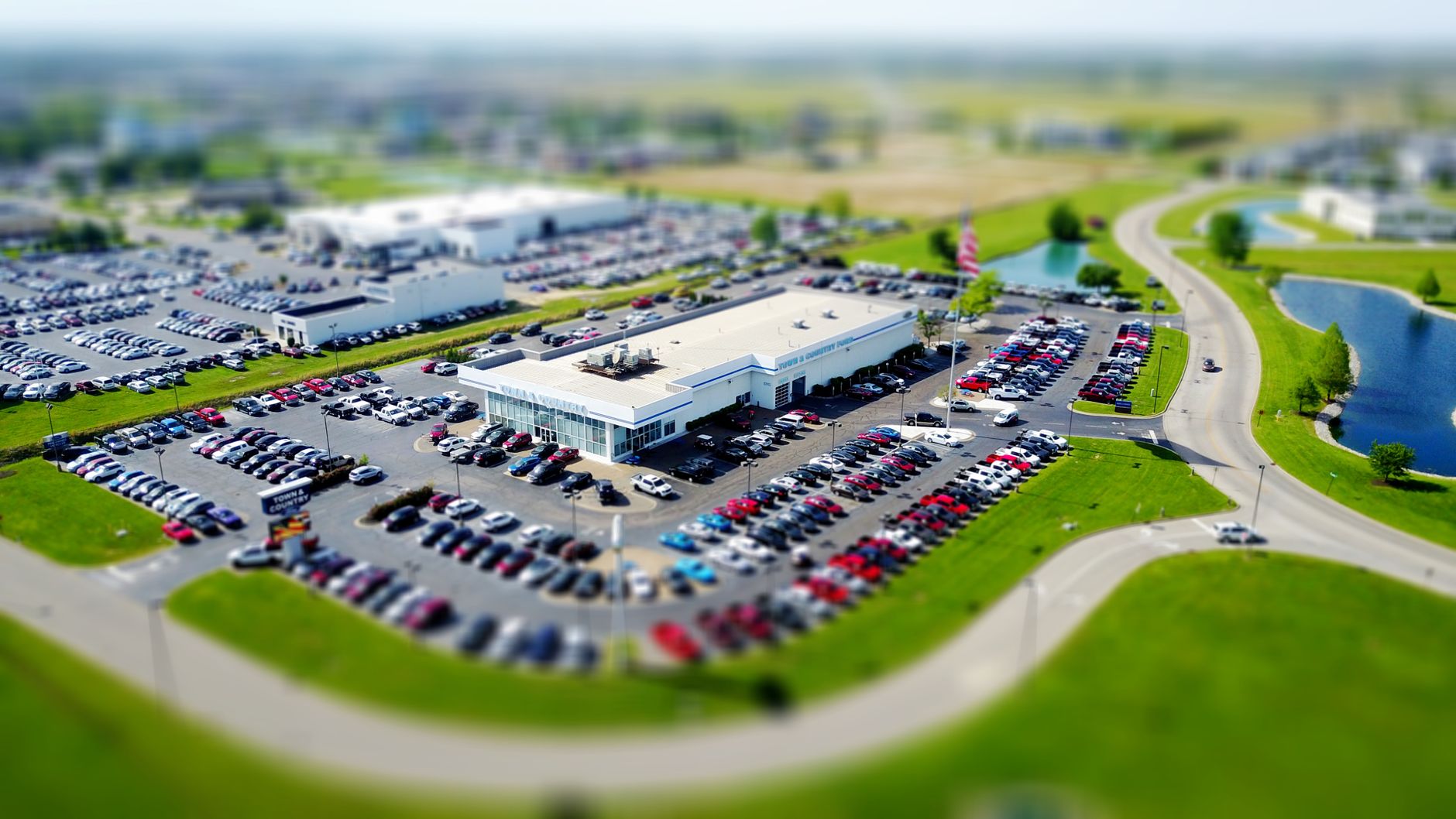 Aerial view of a car dealership and its vehicle lot