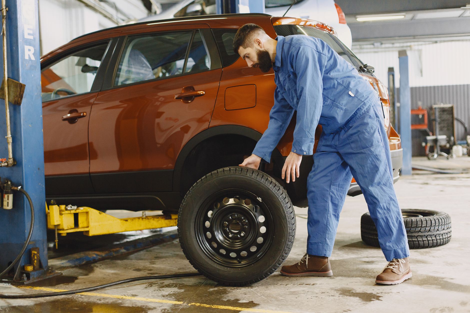 Mechanic fitting a new tire on a car