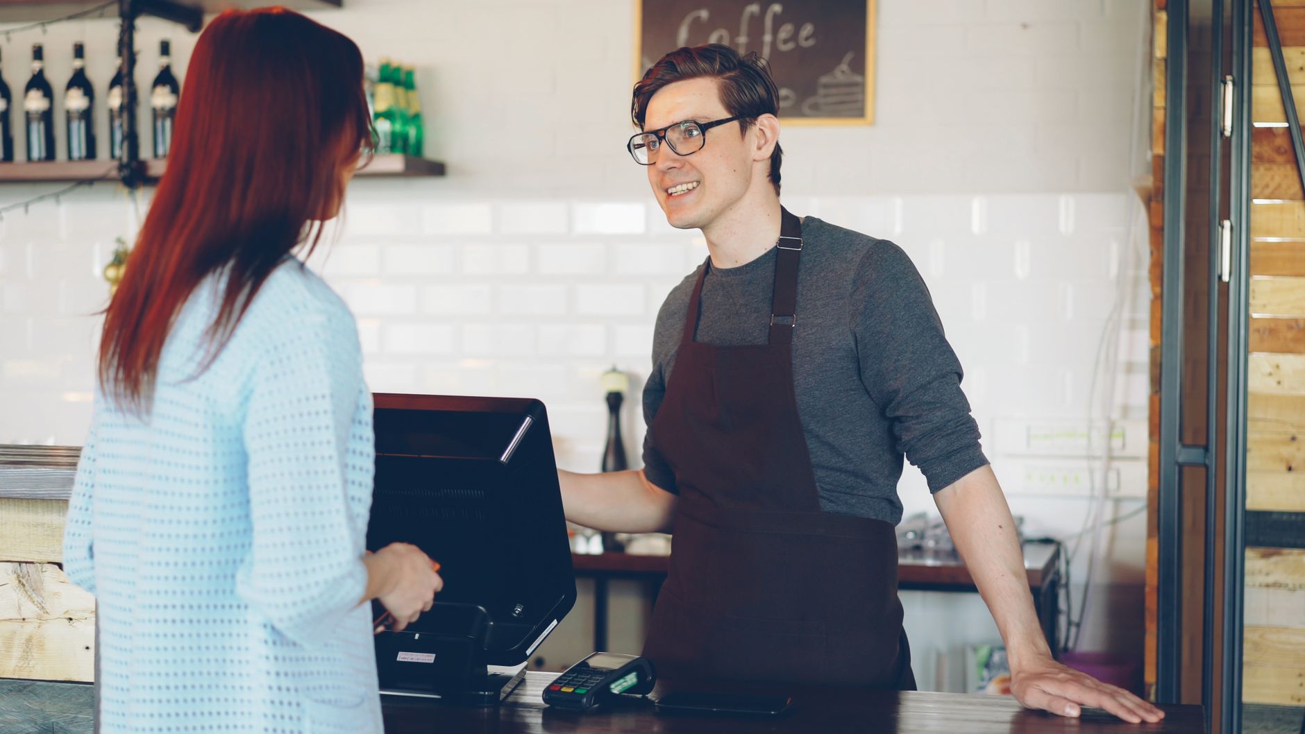 Customer talking to staff at an auto shop service counter