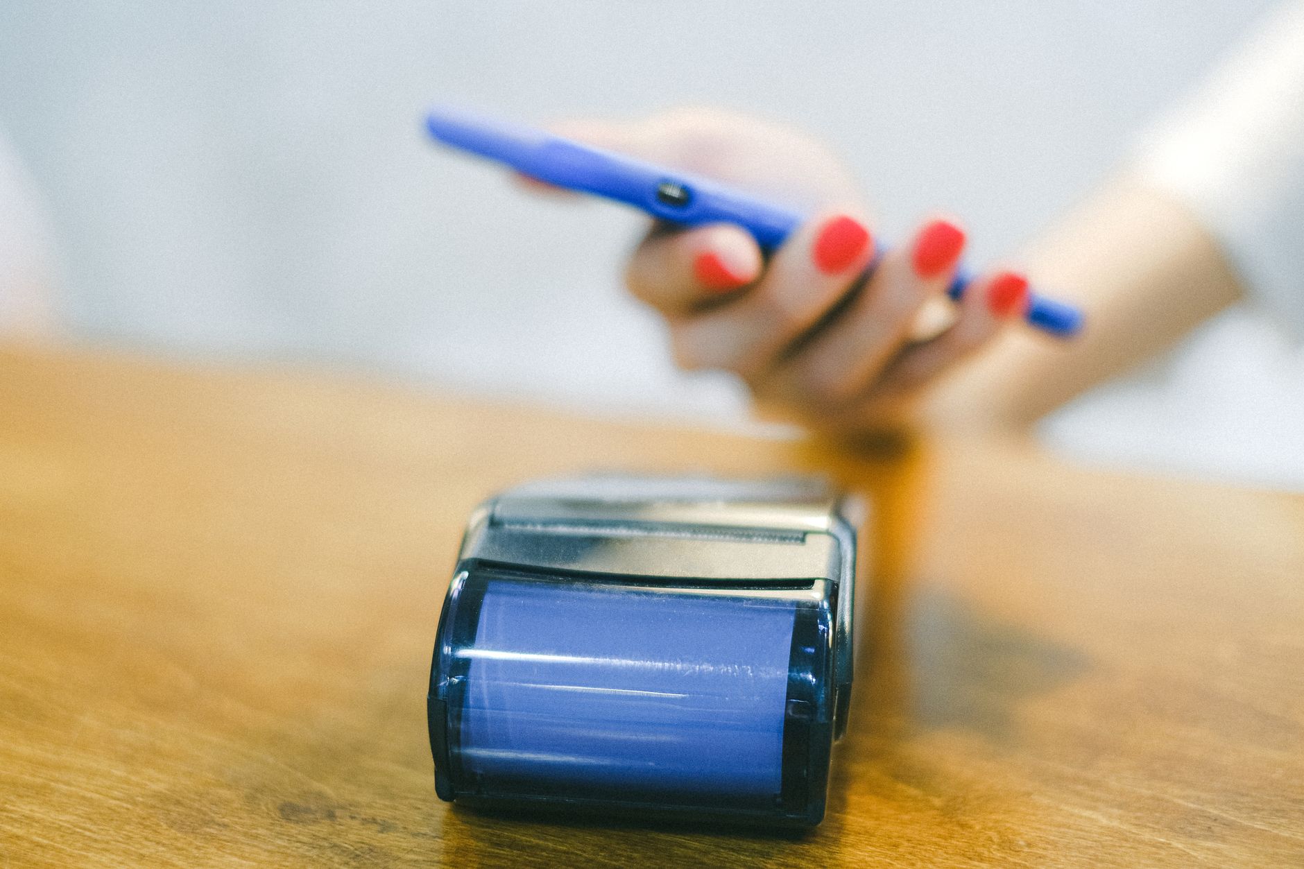 Customer paying with a phone at a card terminal