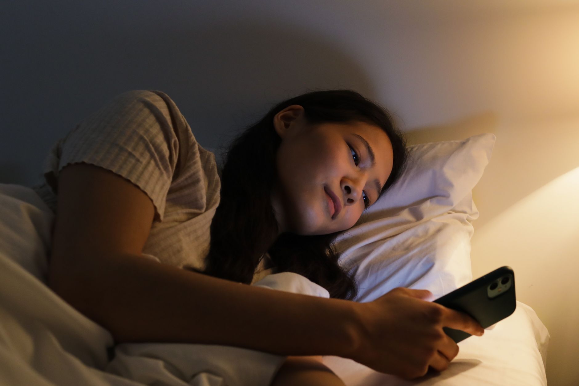 Person checking their phone in the evening