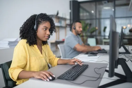 Contact center agent at a desk with a headset