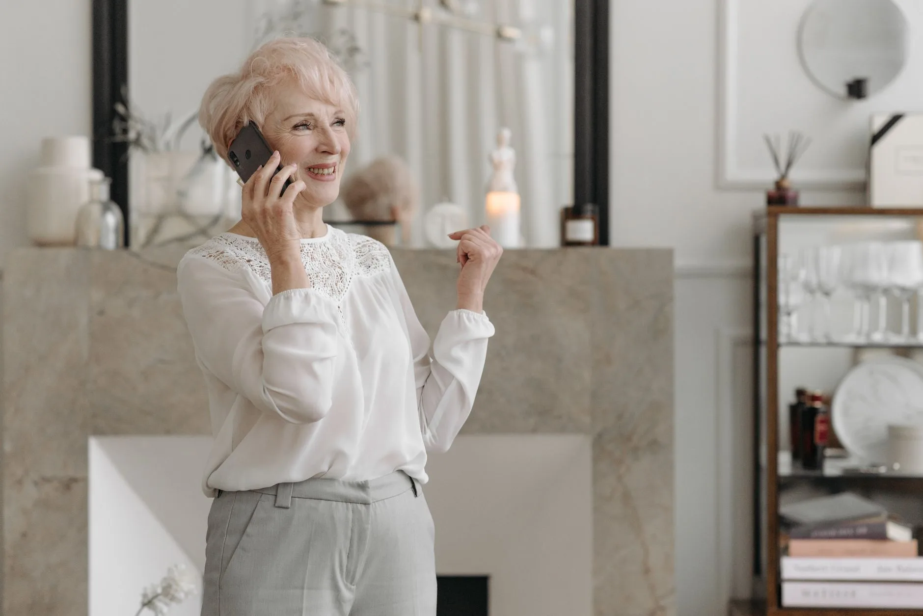 Older woman on a phone call in her living room