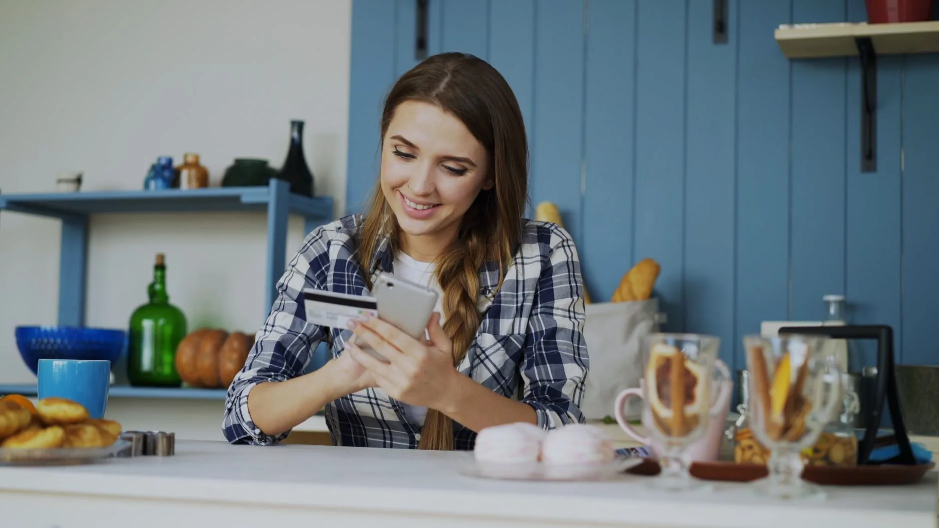 Woman paying a bill on her smartphone at home