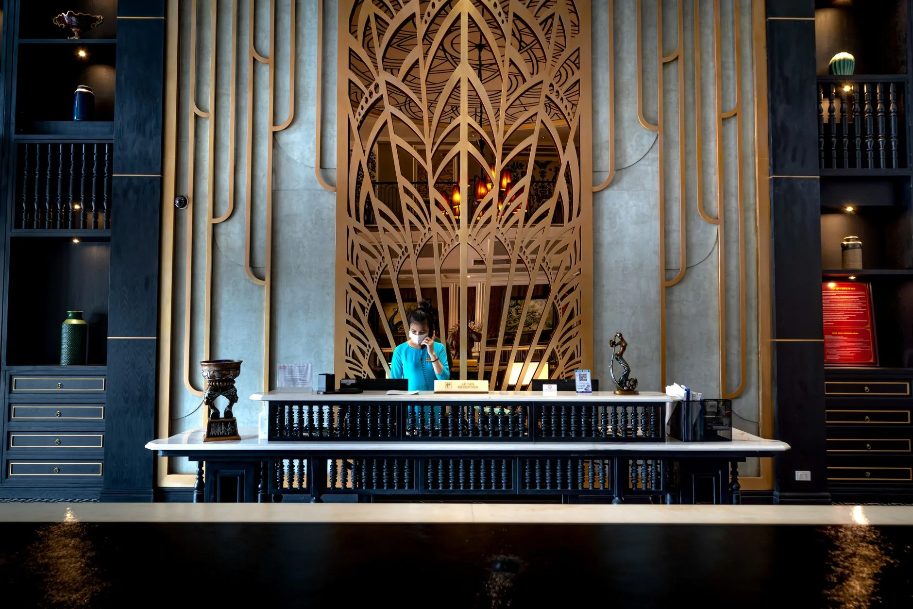 Hotel reception desk where a reservation is confirmed