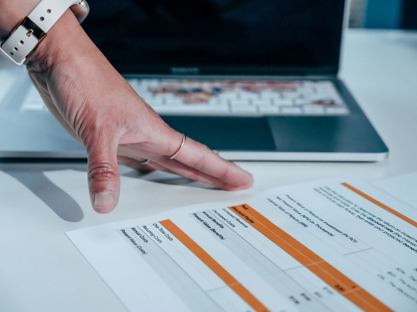 Staff member reviewing a report on a laptop