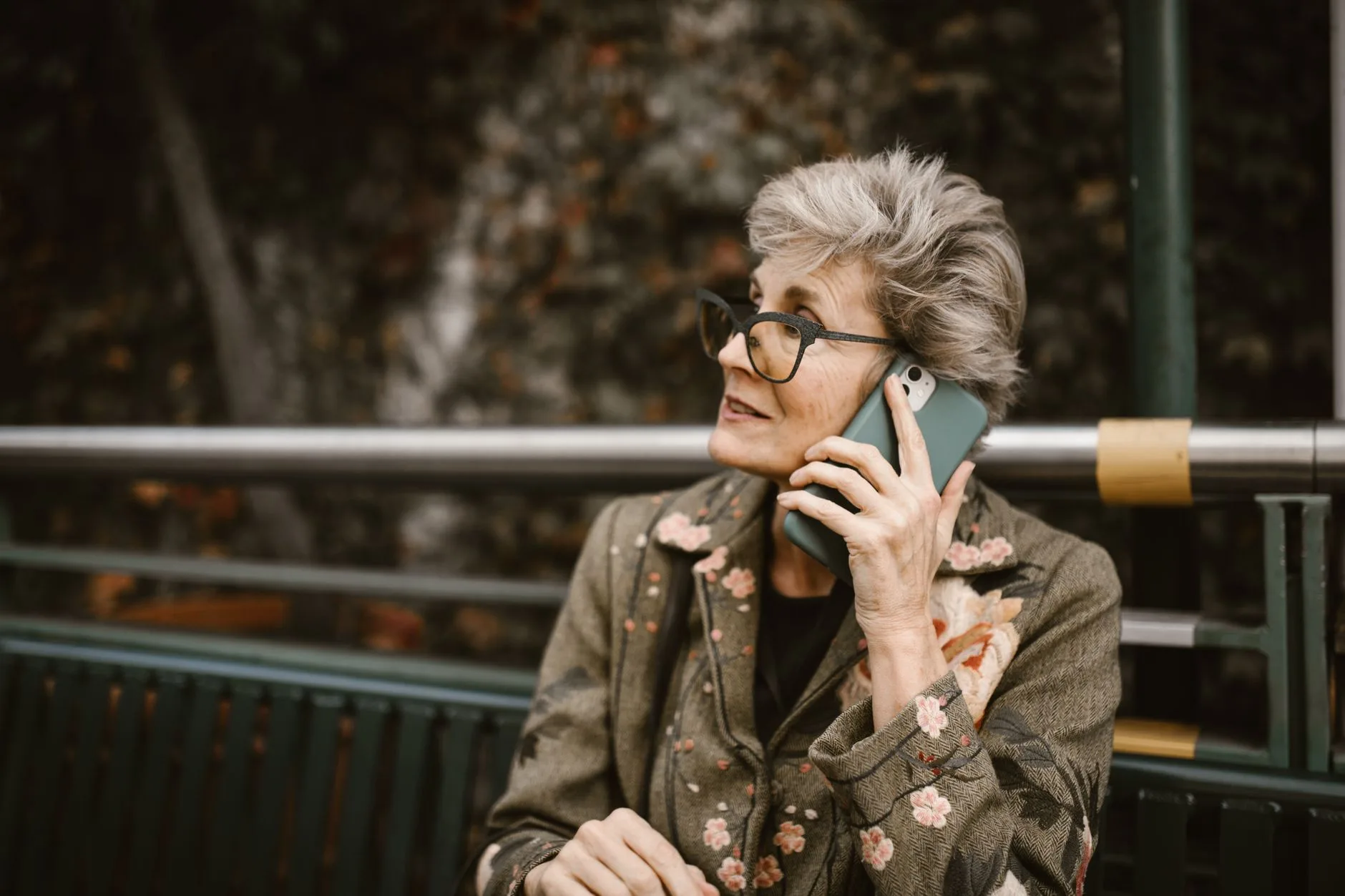 Older woman talking on her phone outdoors