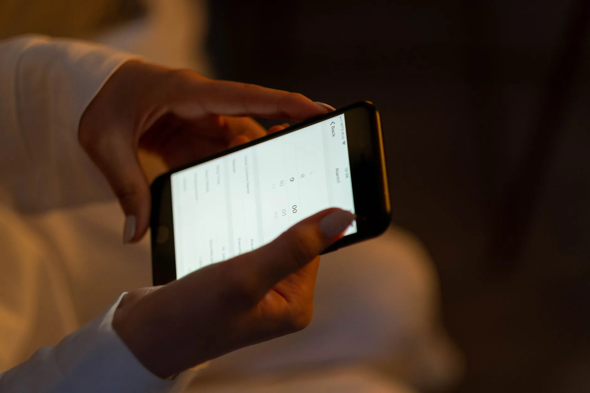 Hand holding a smartphone showing a chart
