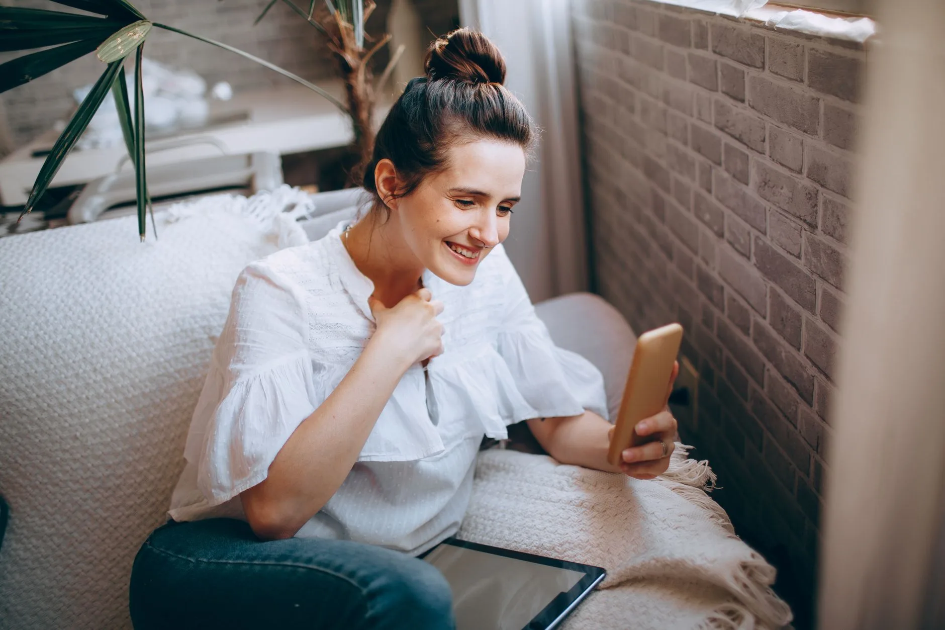 Woman on a sofa using her smartphone