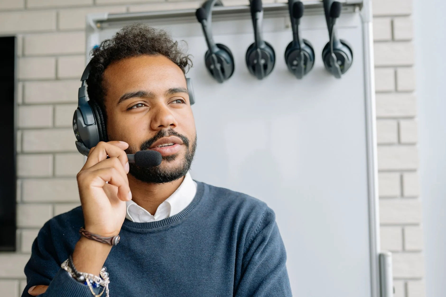 Help desk technician wearing a headset at his desk