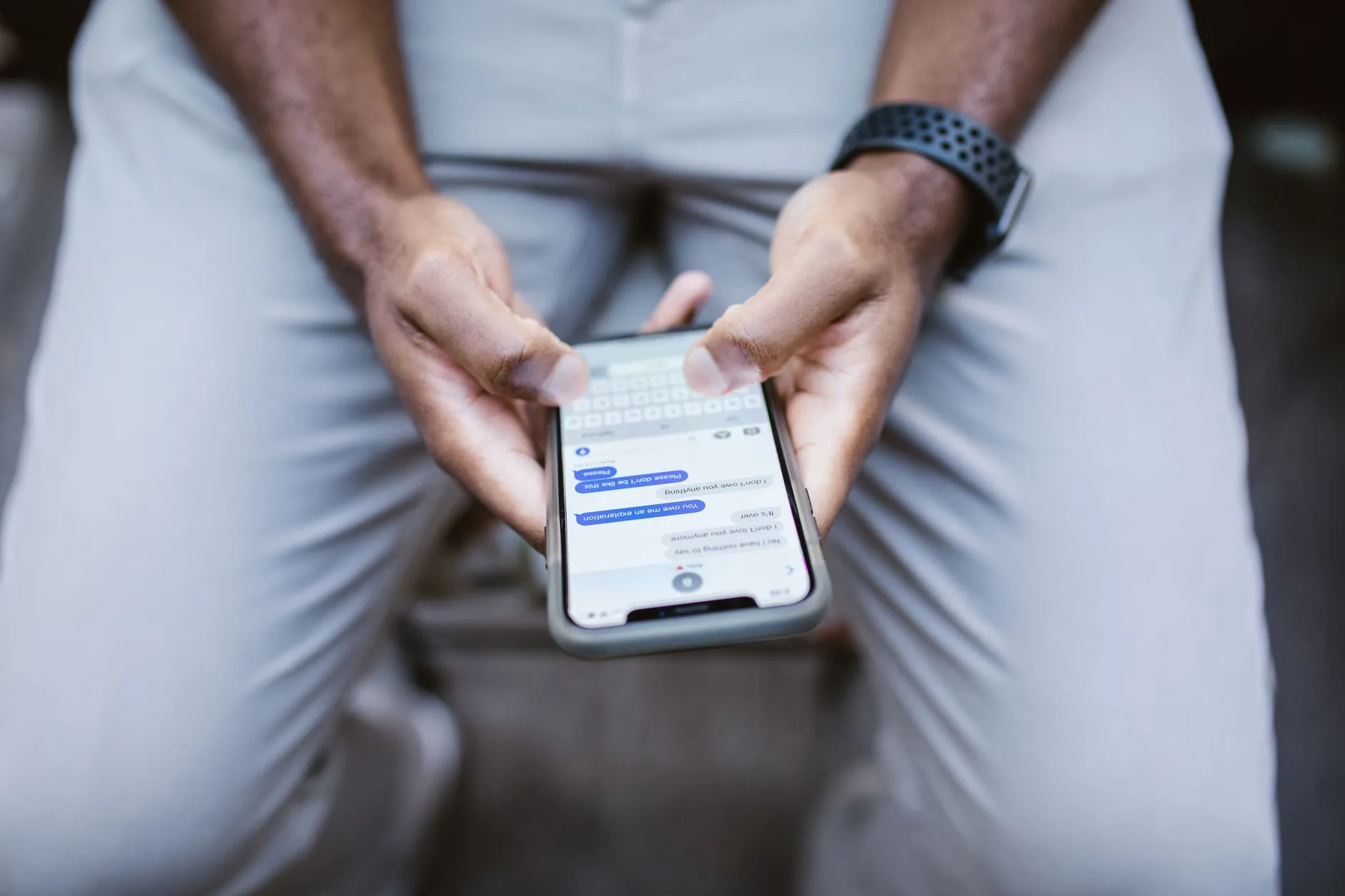 Person holding a smartphone and reading a text message