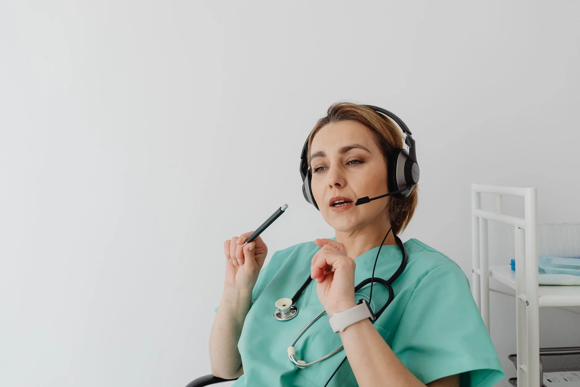 Healthcare staff member on a headset call at her desk