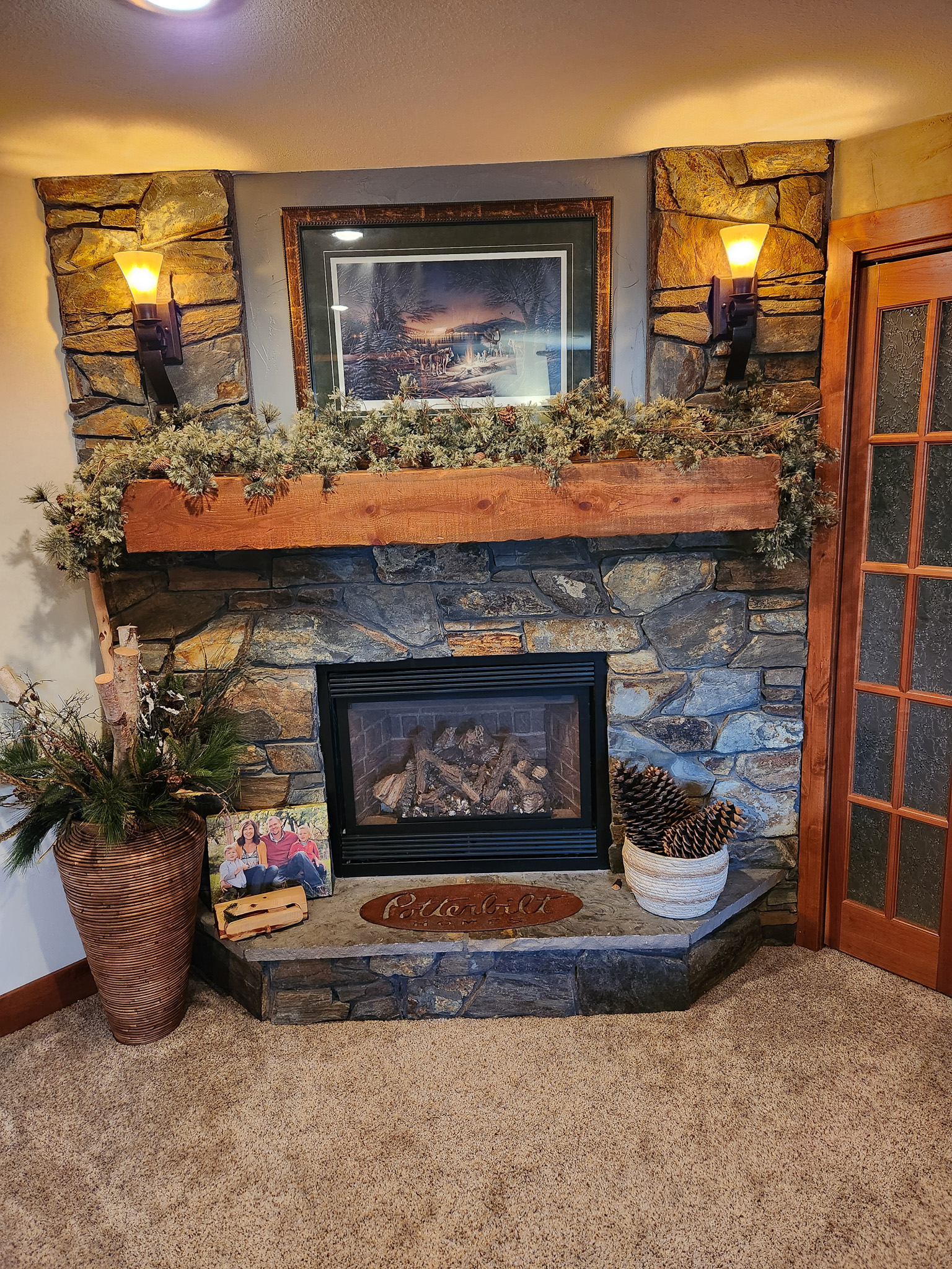 Rock fireplace with wooden mantle built by Potterbilt Homes.