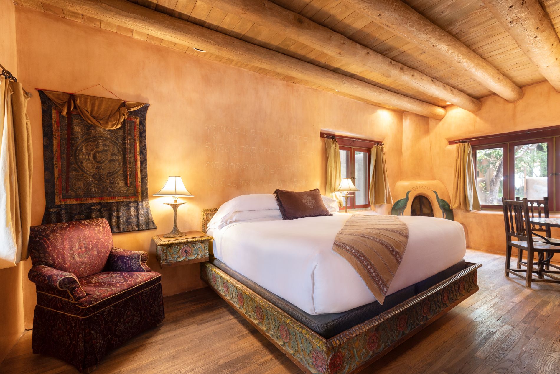 Premier Suite with king bed and fireplace with peacocks painted on it