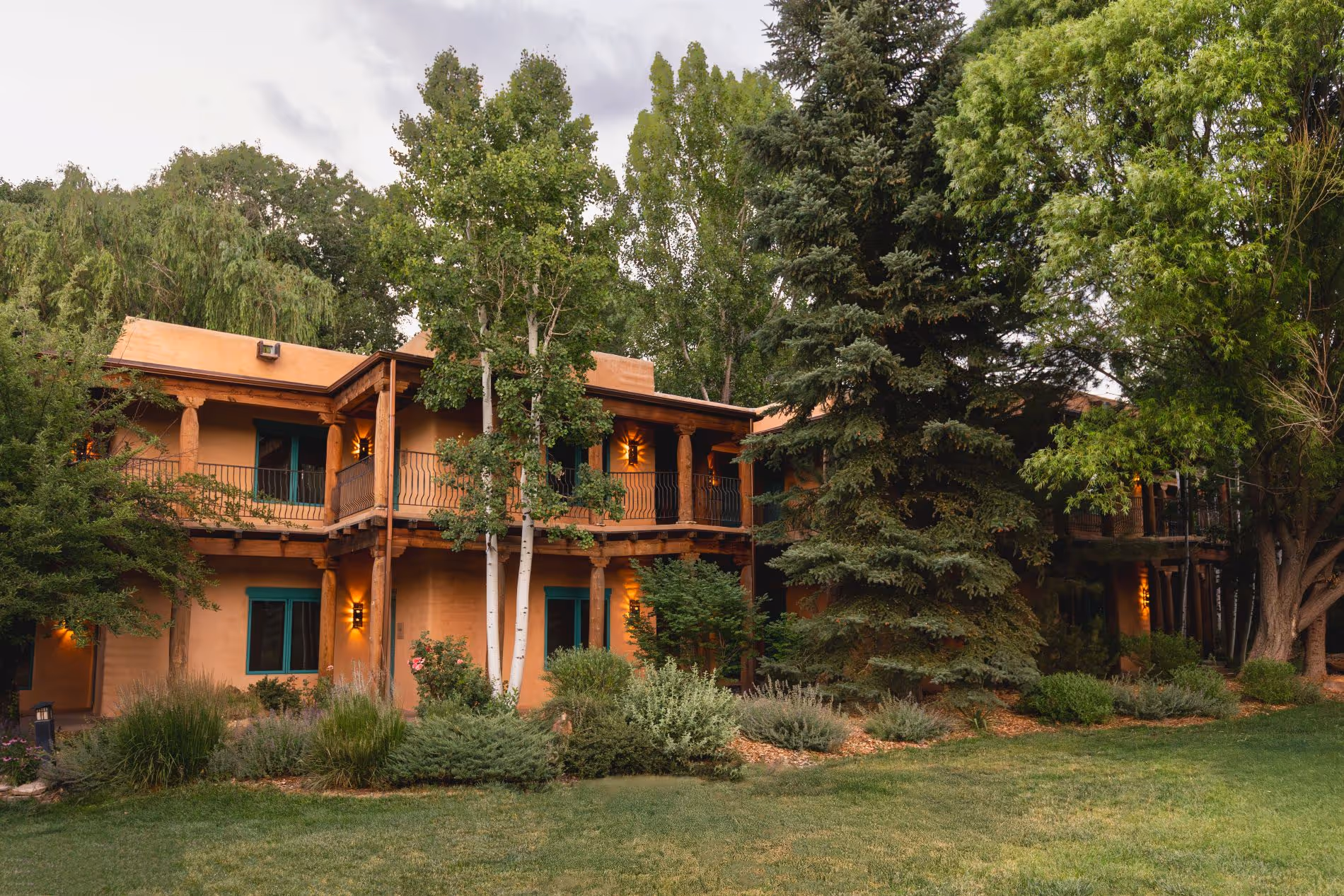 Grounds of El Monte Sagrado with green grass and trees