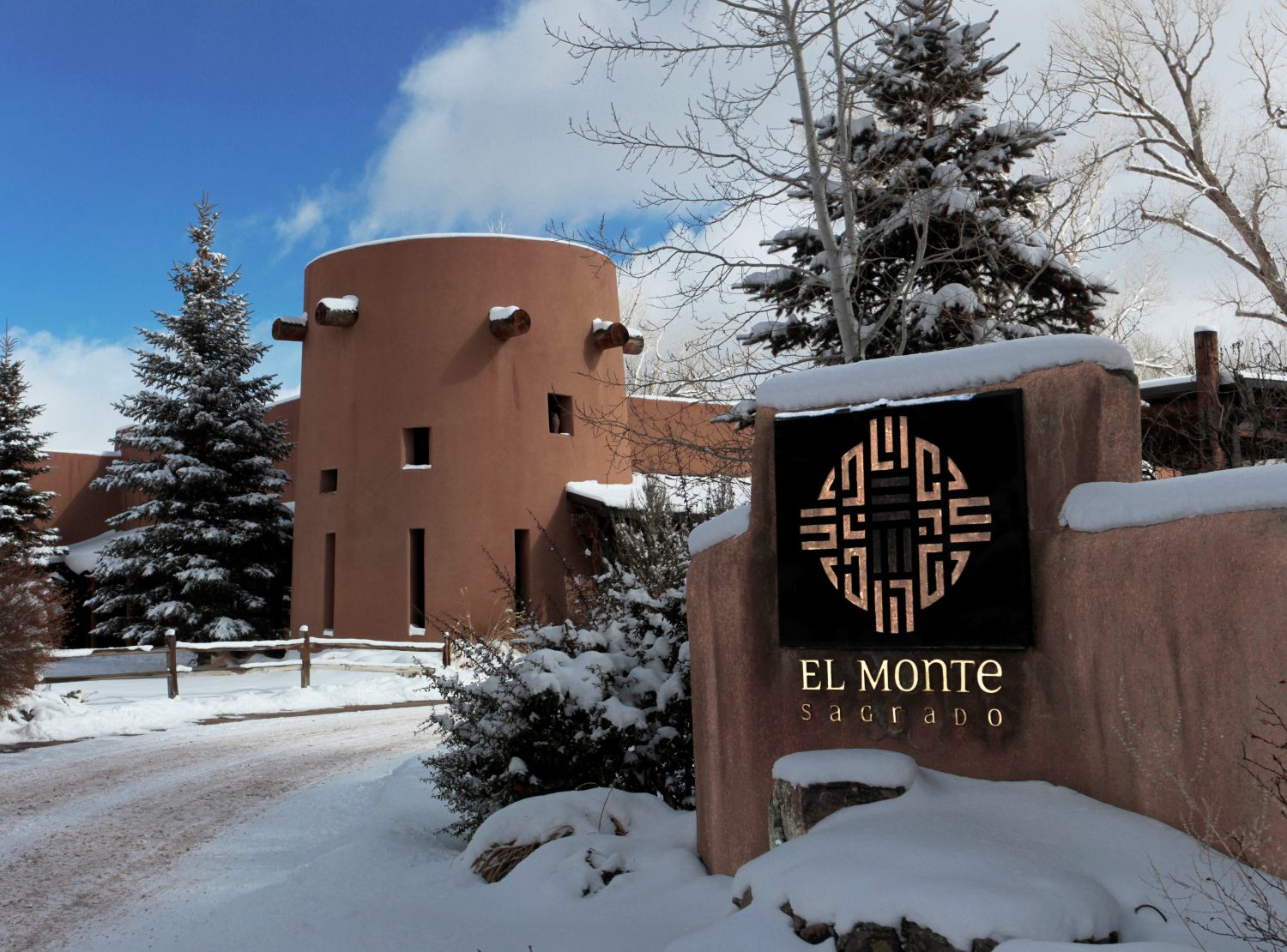 Driveway leading up to exterior of El Monte Sagrado with snow