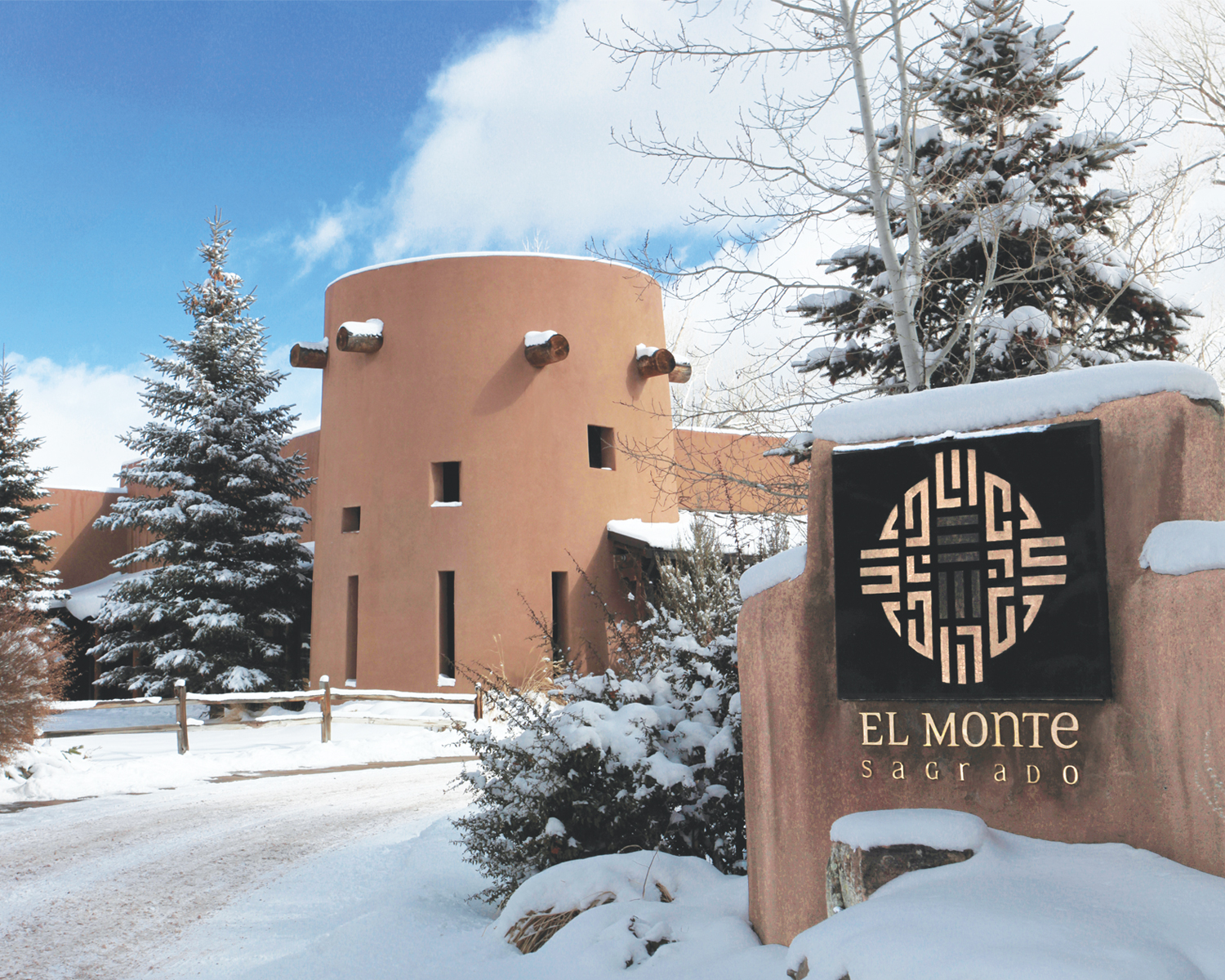 Driveway leading up to exterior of El Monte Sagrado with snow