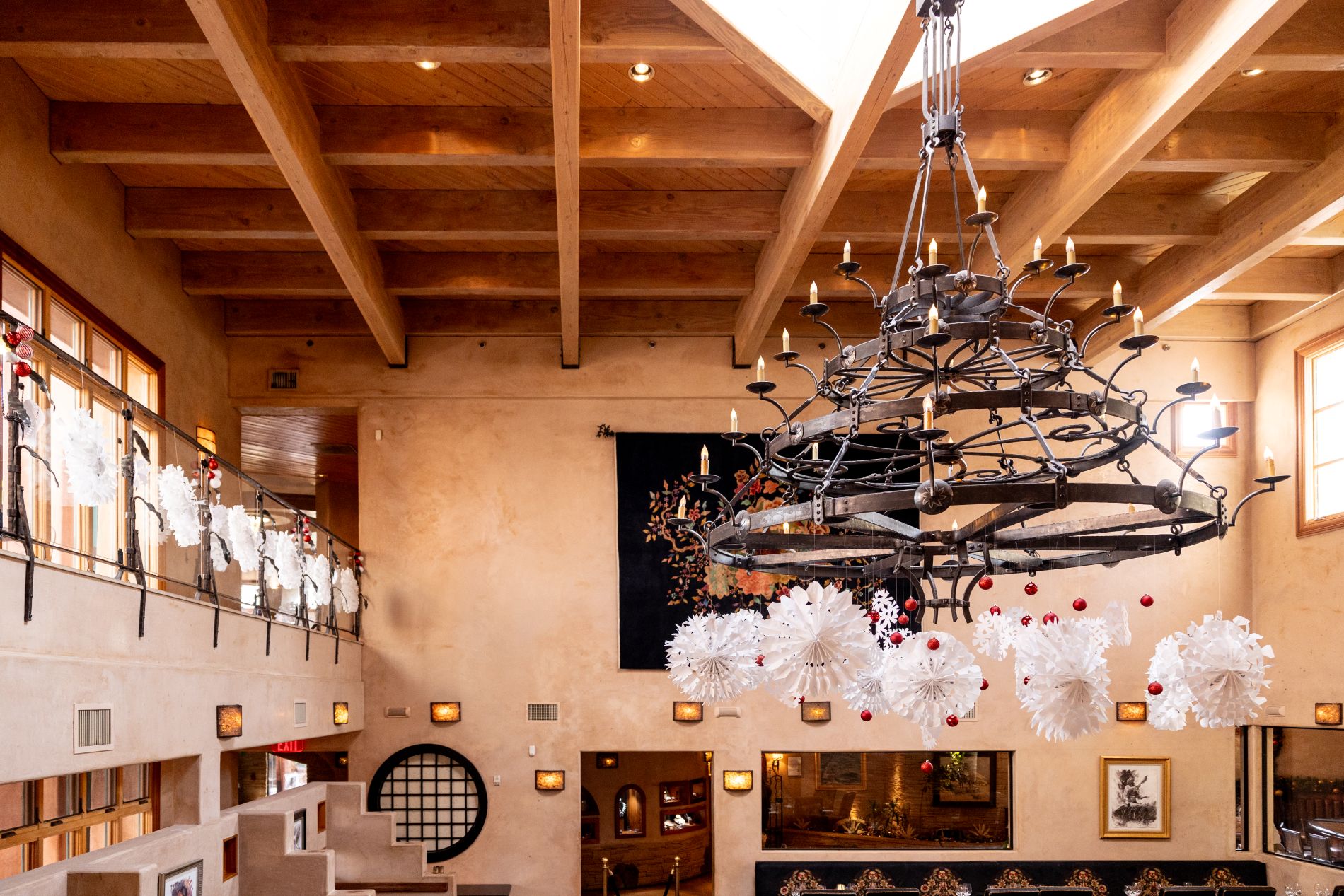 Chandelier in De La Tierra with white snowflake decorations hanging