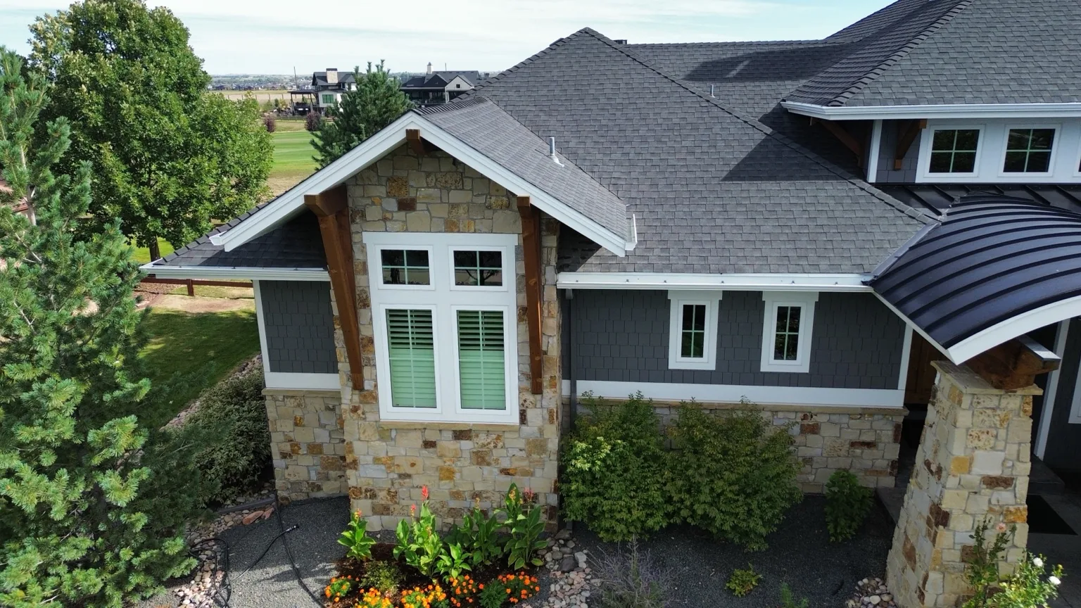 Front view of the original asphalt shingle roof before replacement in Timnath.