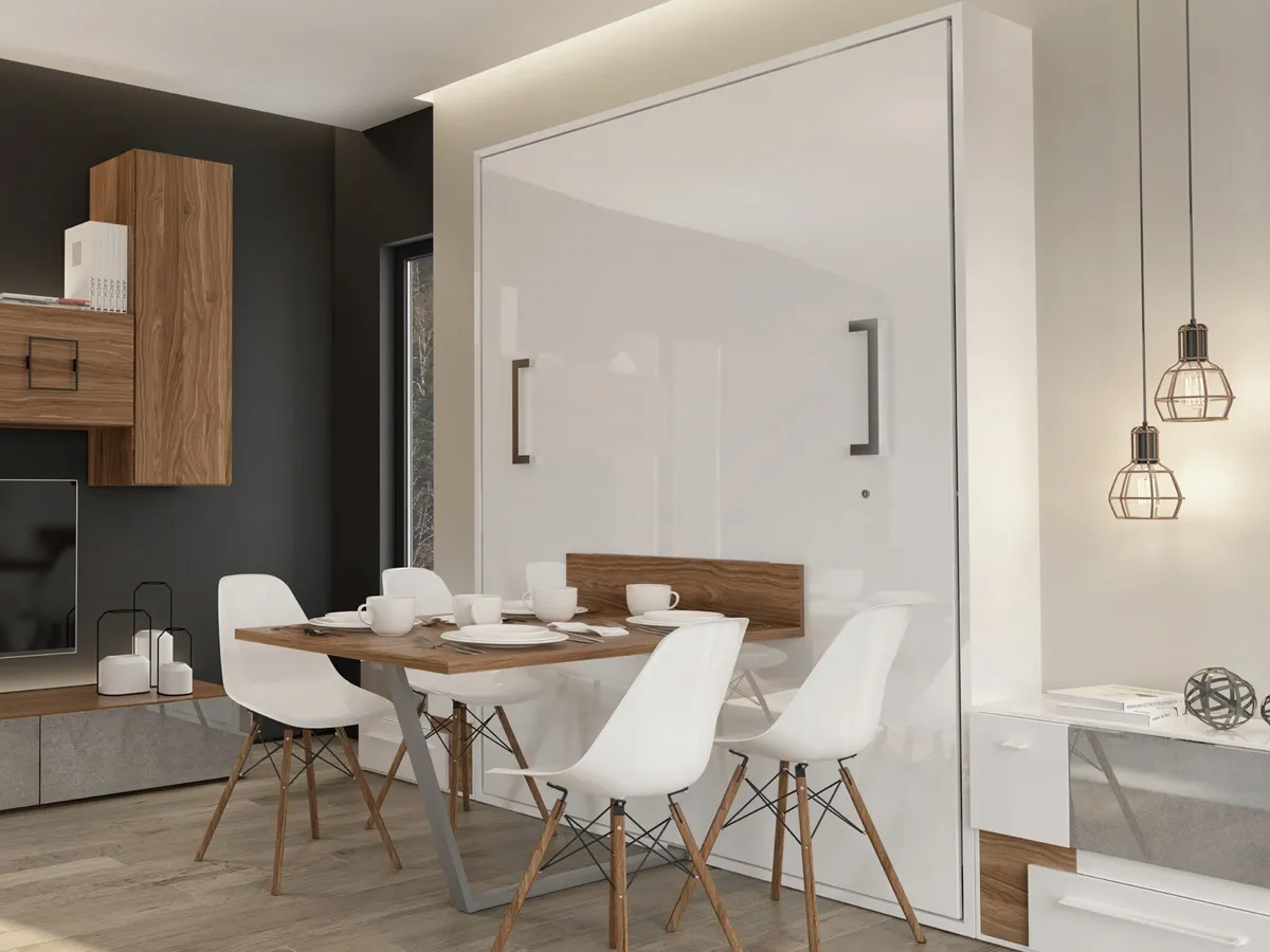 Closed white Murphy bed with its fold-down table set for four, turning a compact room into a dining space