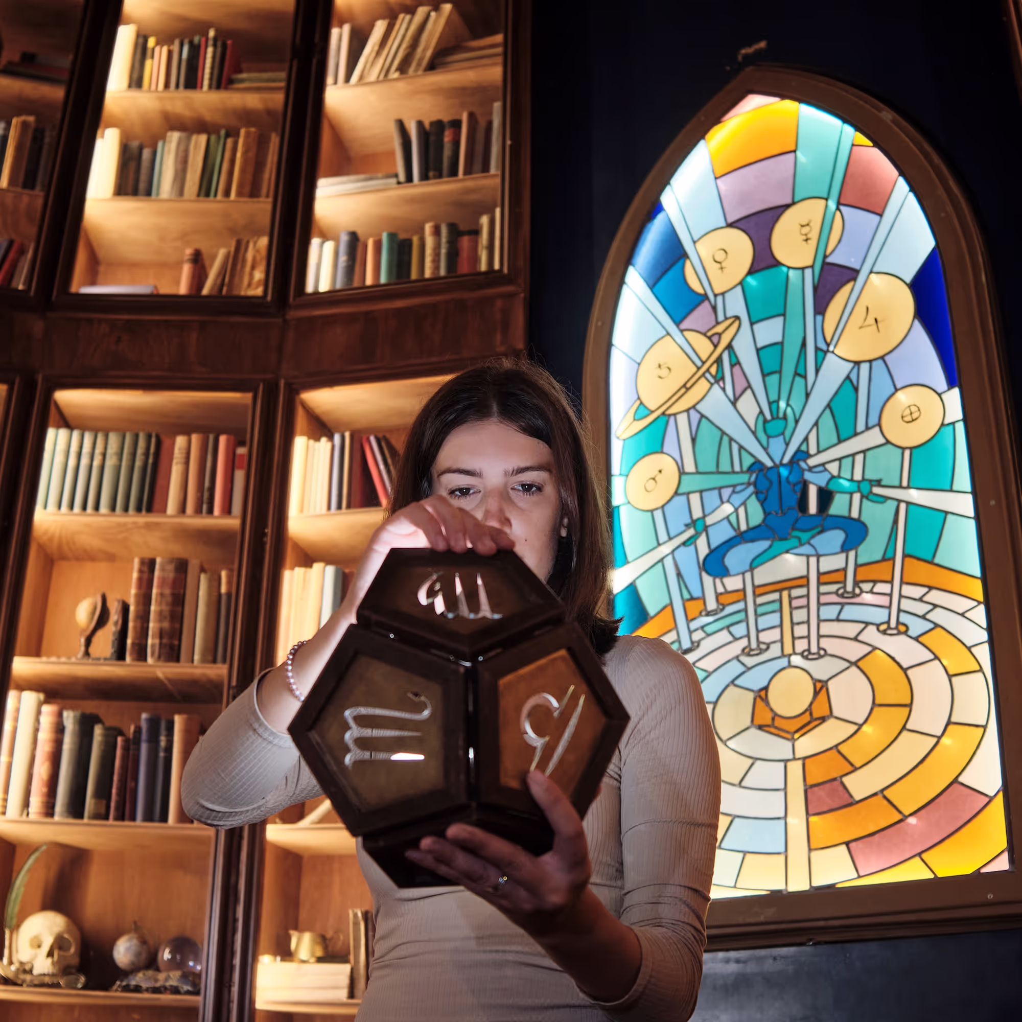 person holding a dodecahedron in the alchemist escape room in amsterdam