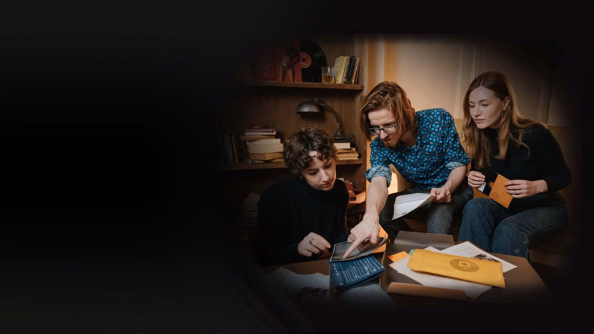 Three people solving clues and examining documents from The Medusa Report escape room board game.