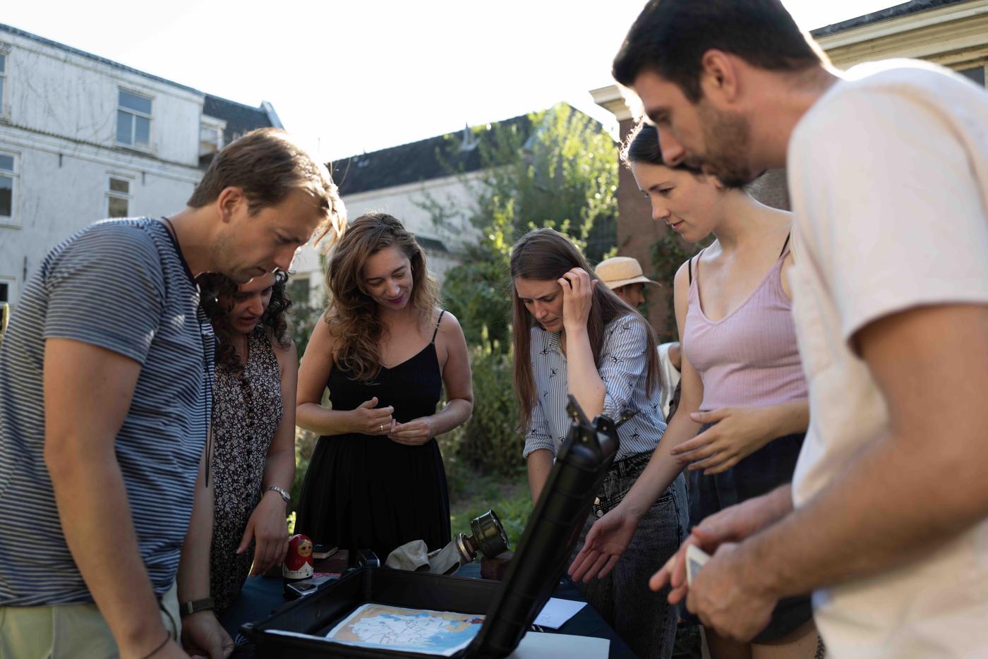 A team leaning over a table together, working something out