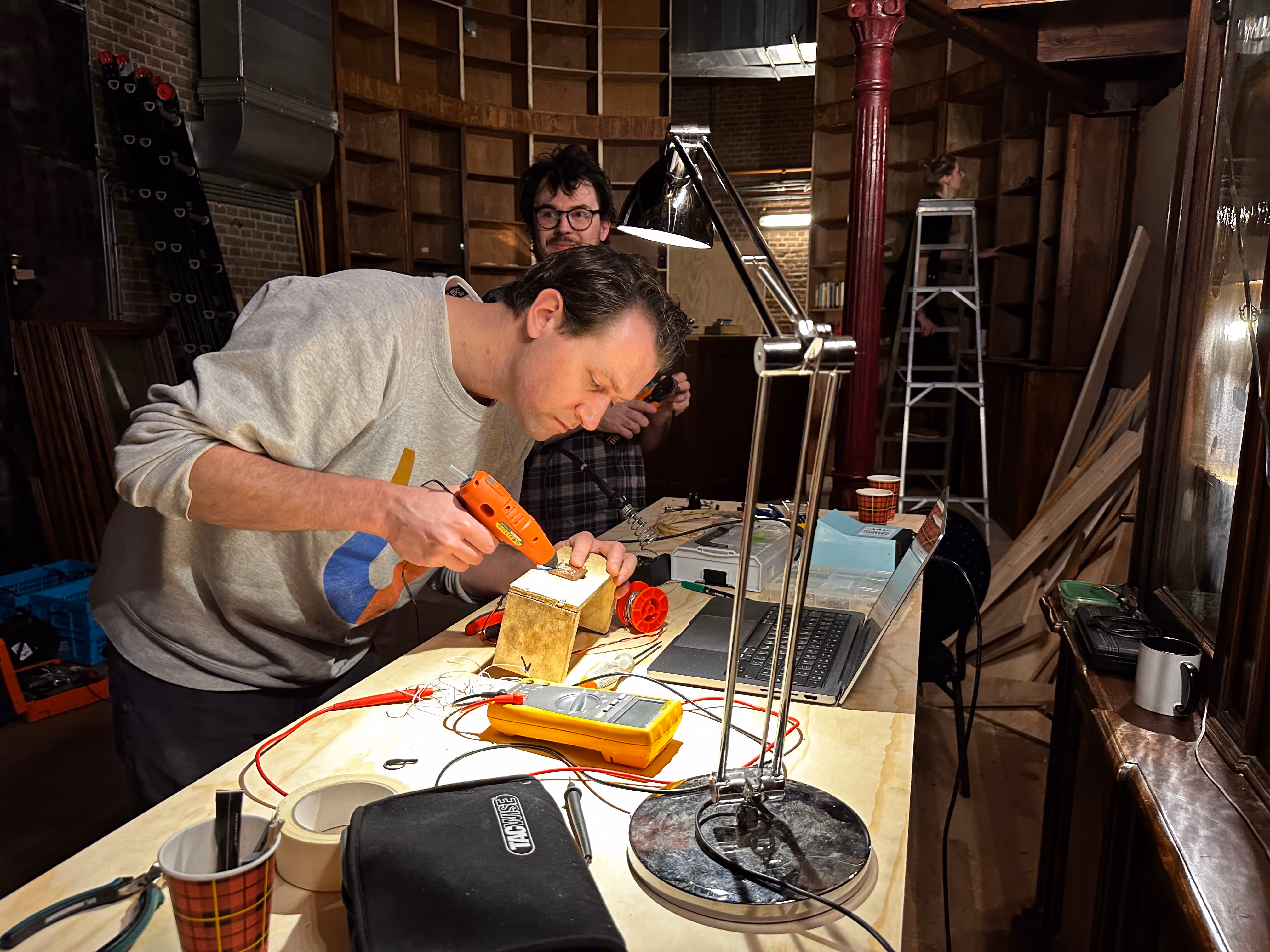 Artists working on setting up the puzzles for the alchemist escape room in Amsterdam