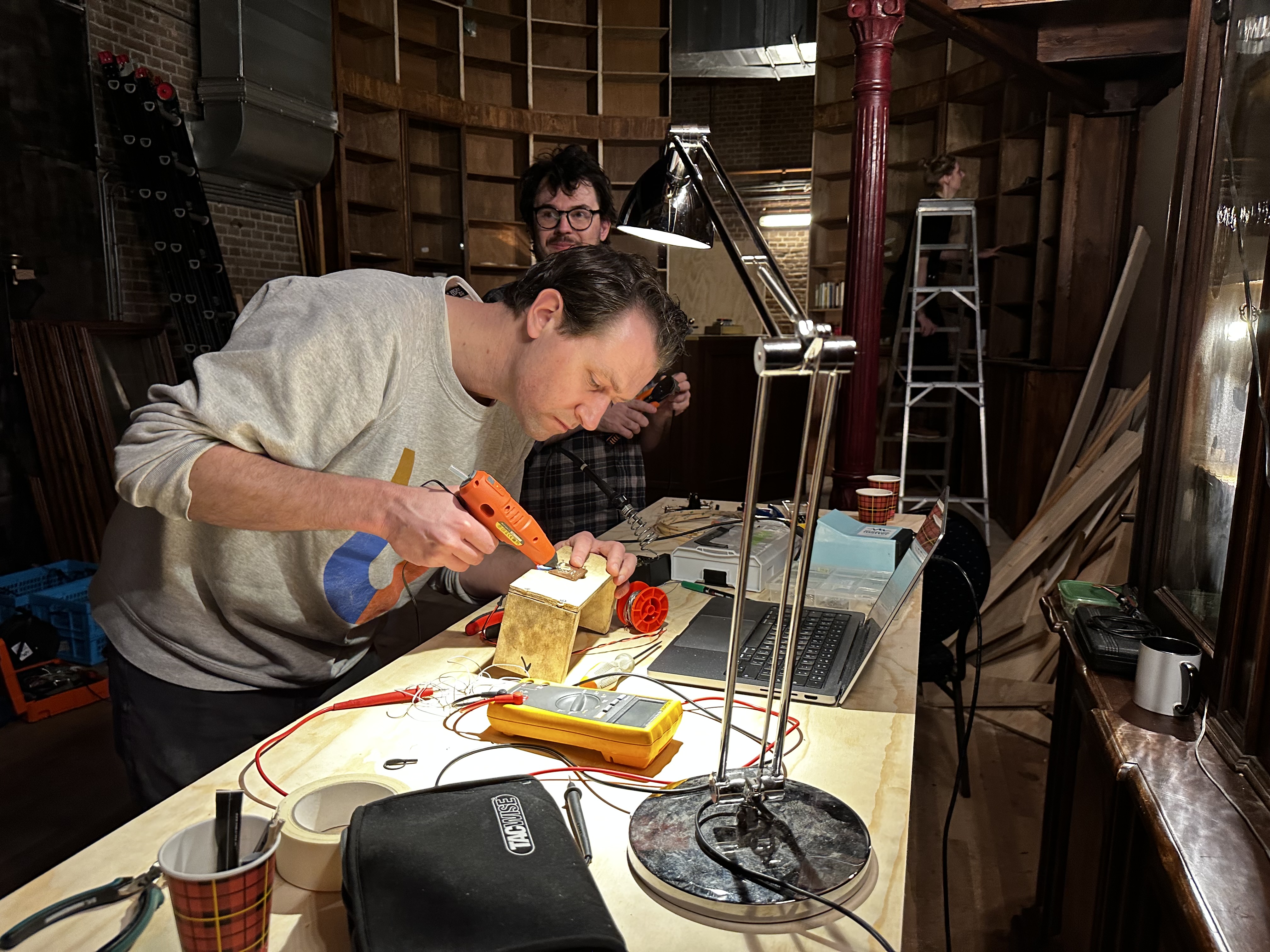 Artists working on setting up the puzzles for the alchemist escape room in Amsterdam