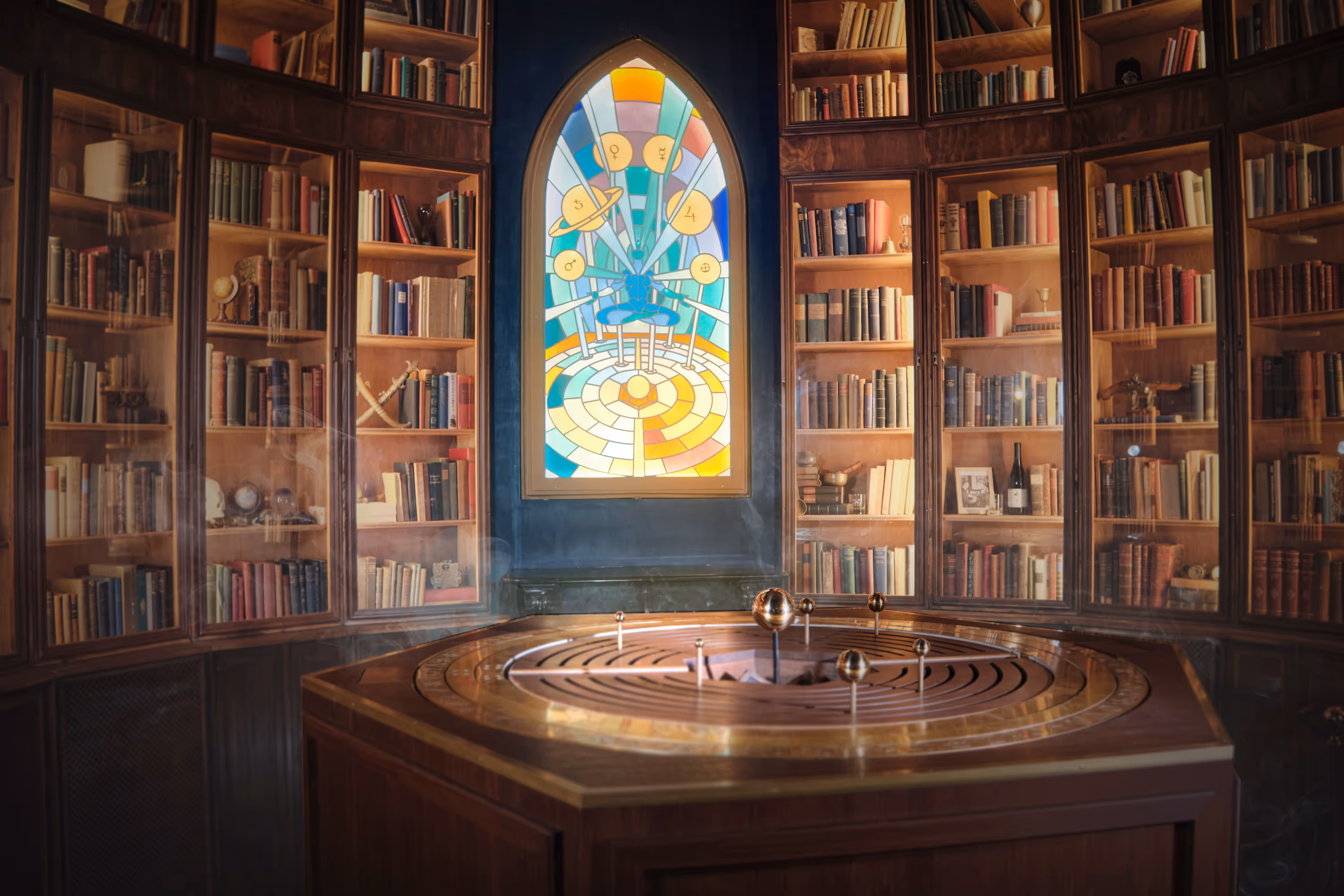 an alchemist's altar with a colorful window and bookshelves