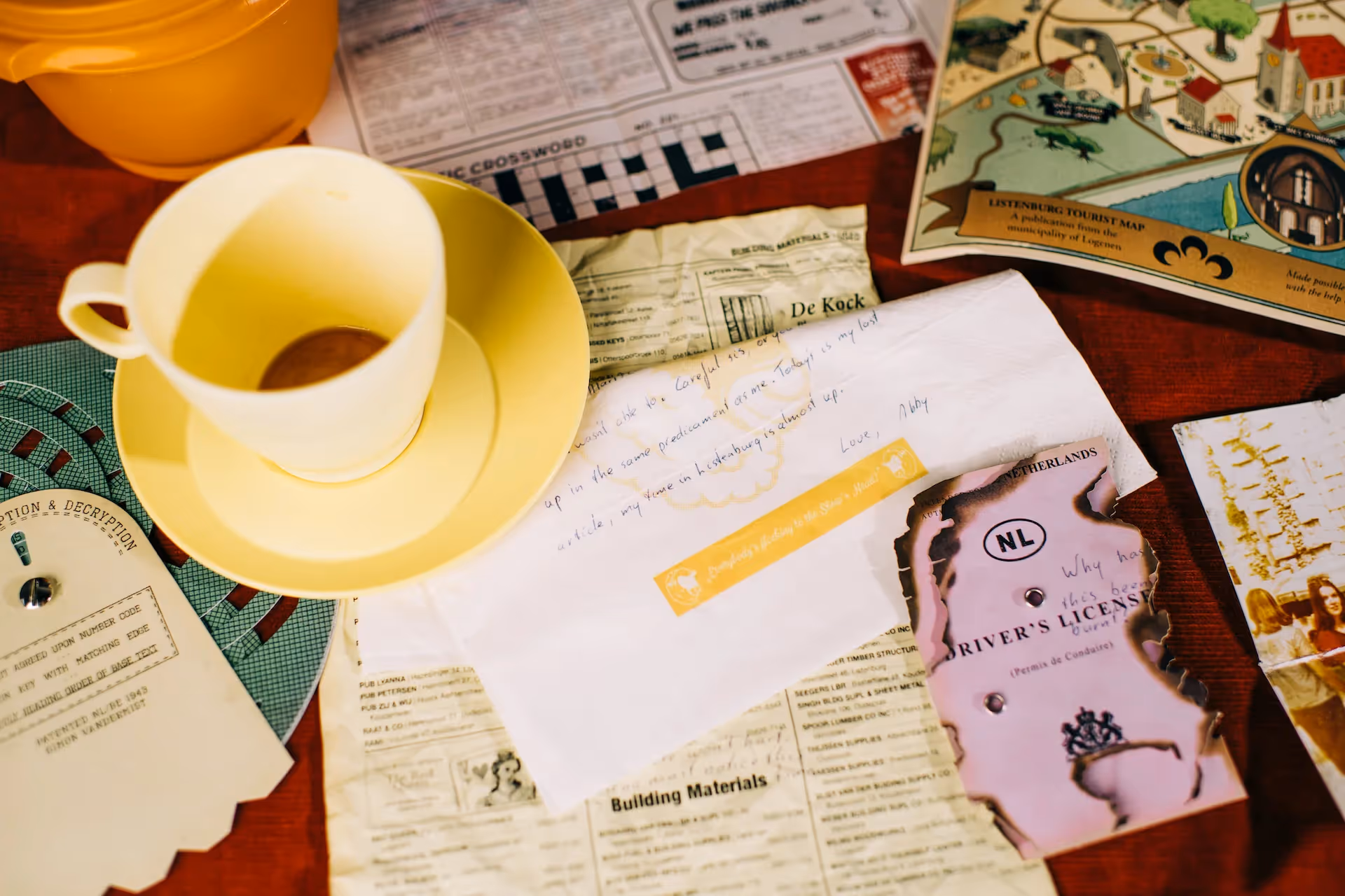 A handwritten warning on a napkin and a burnt Netherlands driver's license from the Abby Vandermist investigation case files.