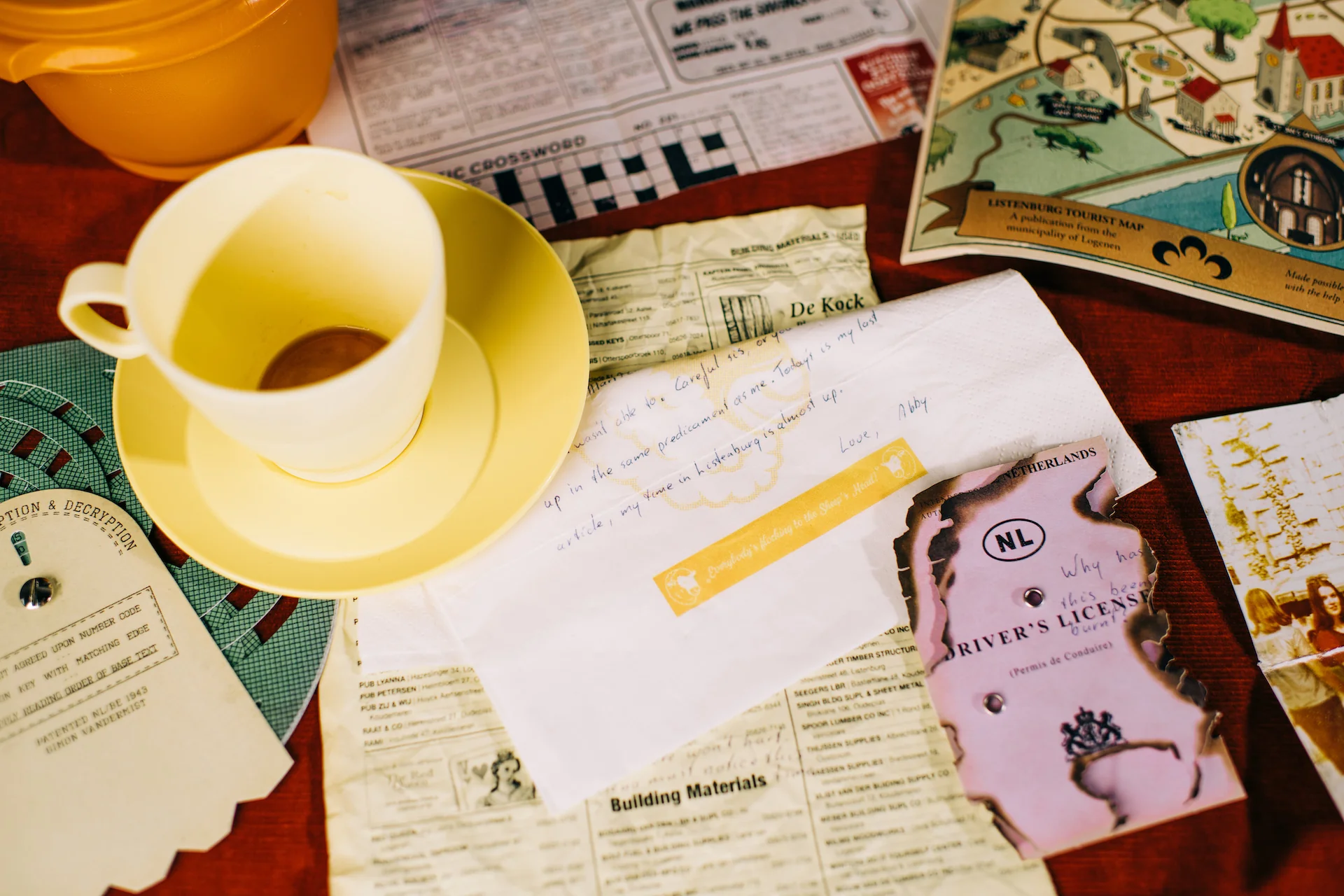 A handwritten warning on a napkin and a burnt Netherlands driver's license from the Abby Vandermist investigation case files.