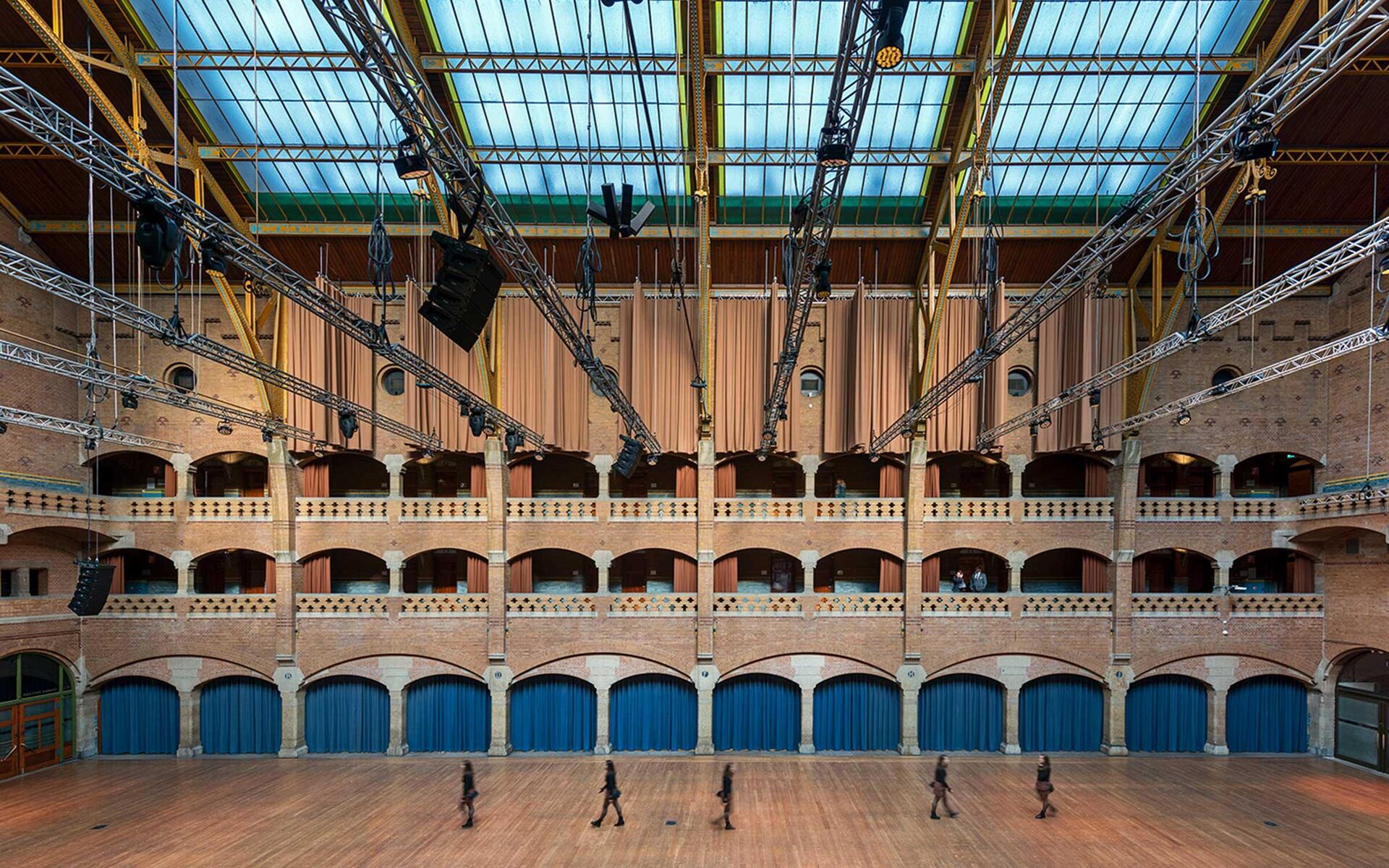 a large room with stage lights hanging from the ceiling