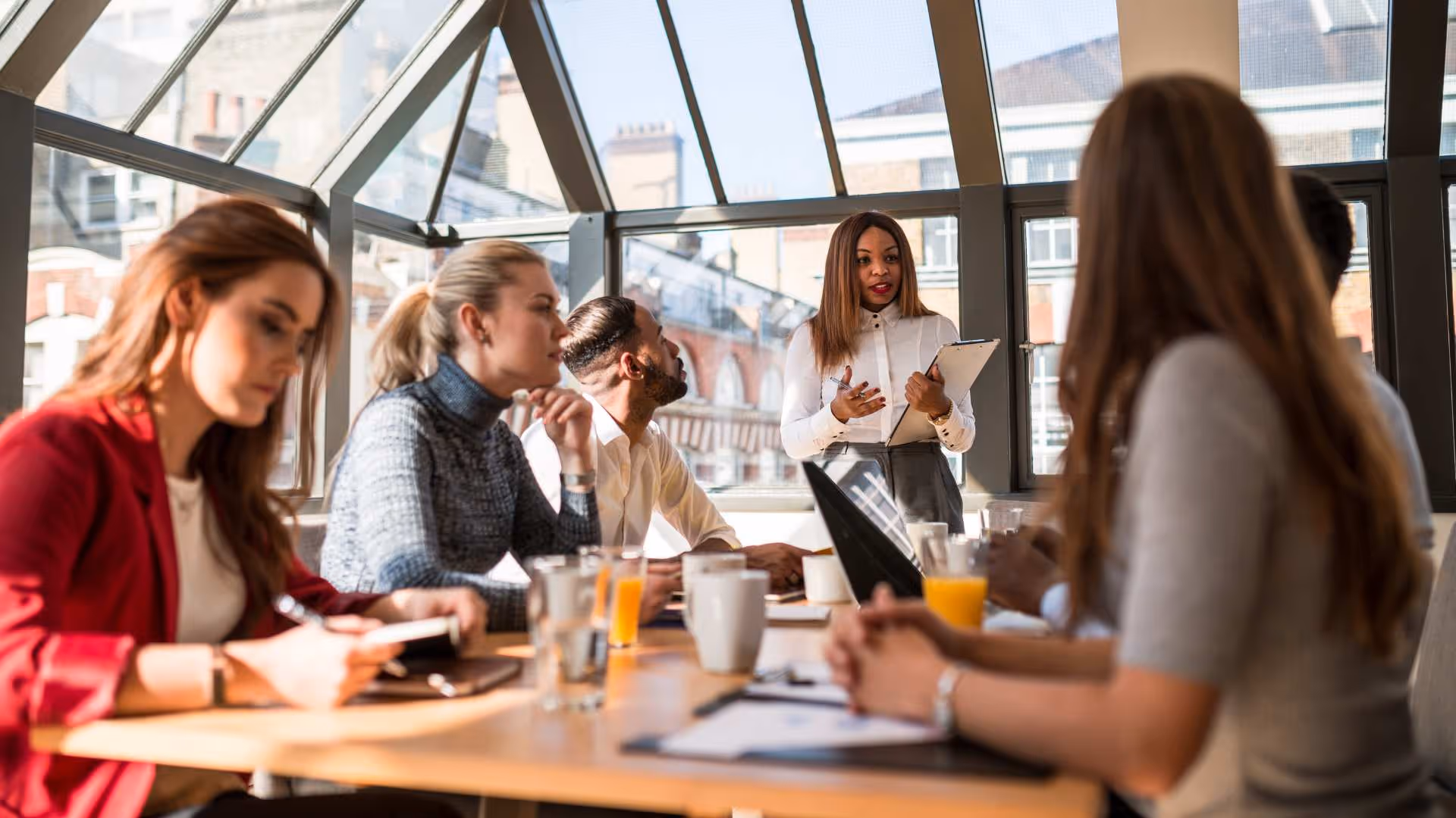 Professional group engaged in a corporate storytelling workshop led by an expert instructor in a modern Amsterdam office space.