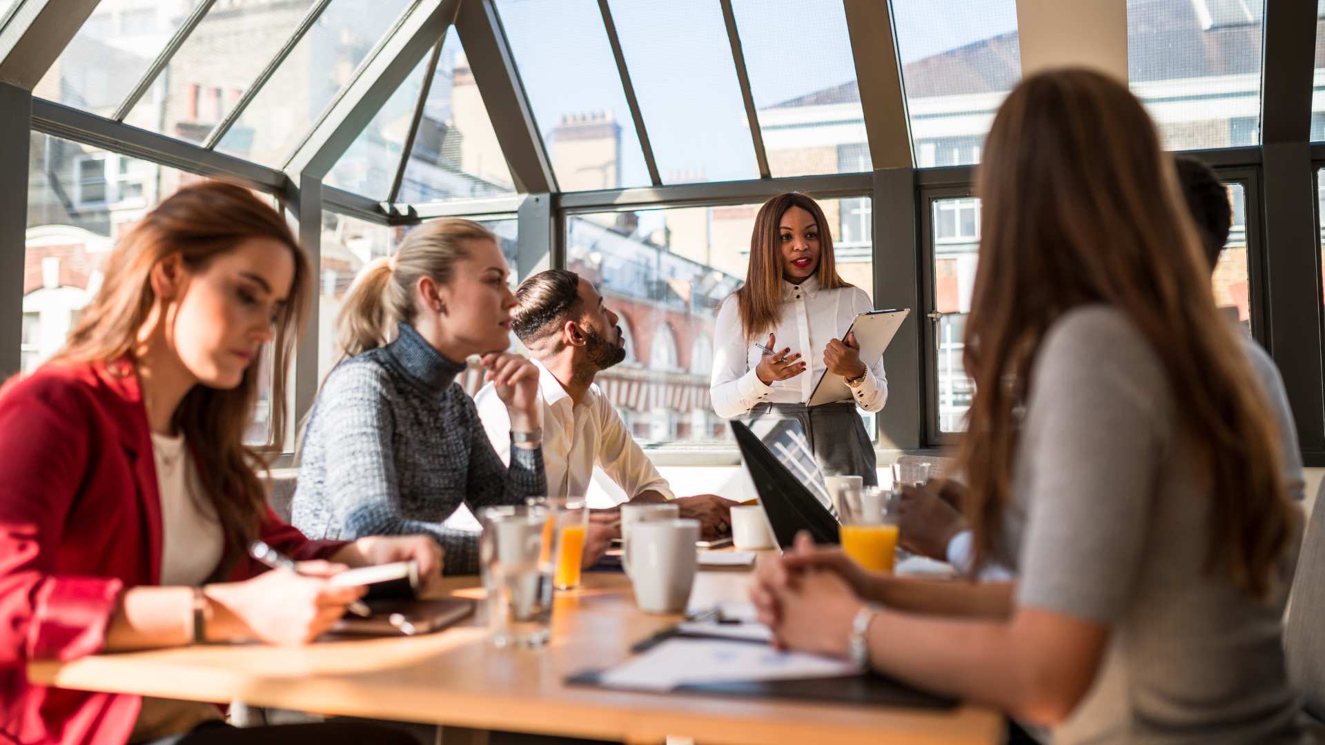 Professional group engaged in a corporate storytelling workshop led by an expert instructor in a modern Amsterdam office space.