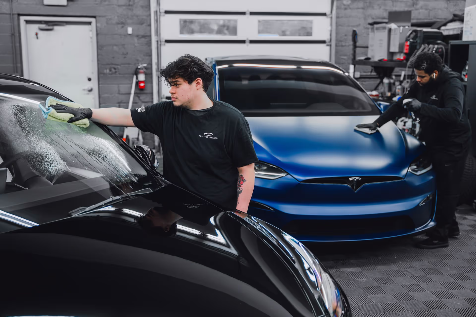 pristine detail workers polish cars