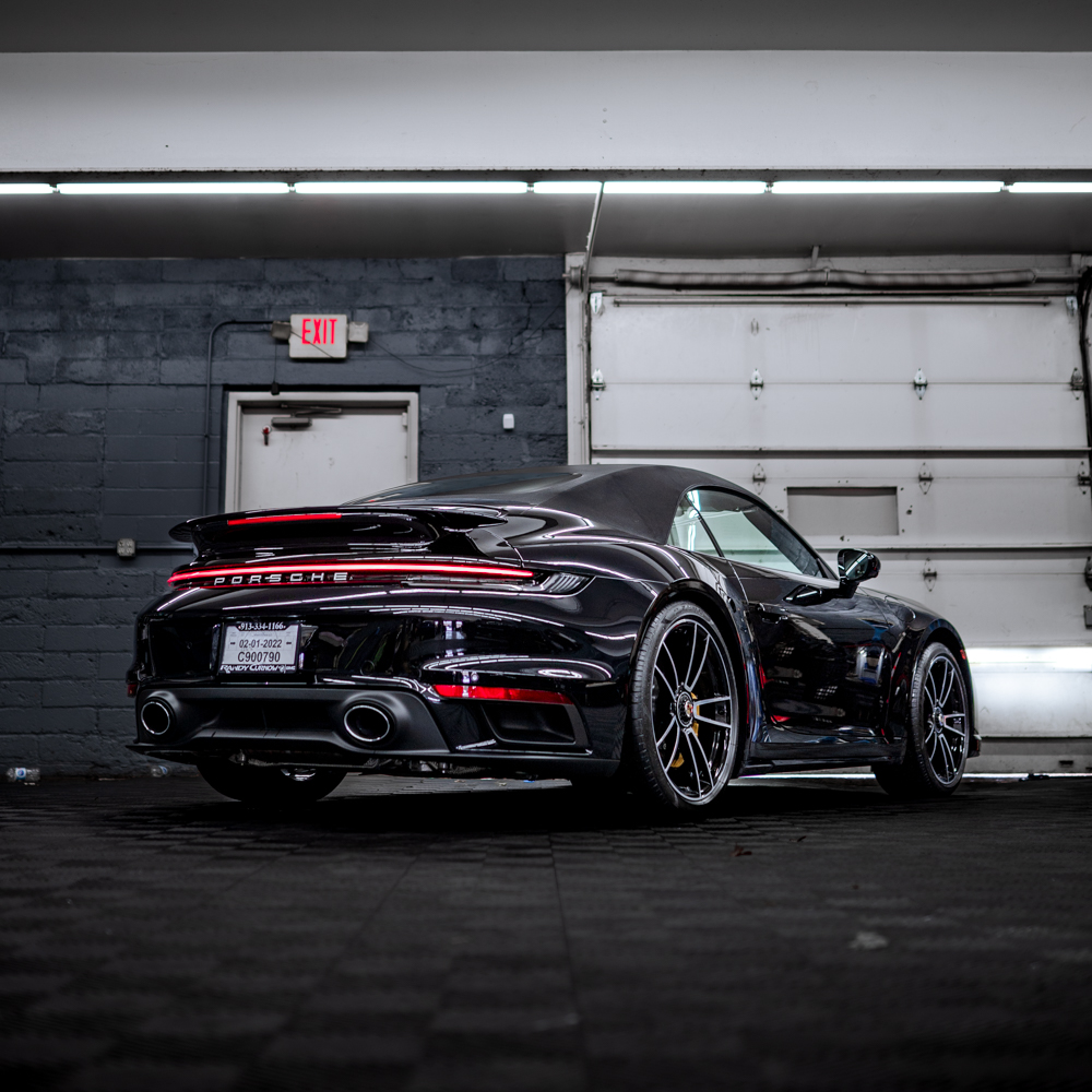 Rear three-quarter view of a black Porsche 911 Turbo S Cabriolet