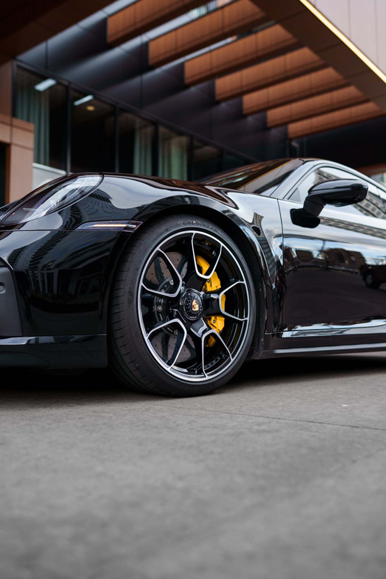 Wheel and yellow brake caliper on the black Porsche 911 Turbo S