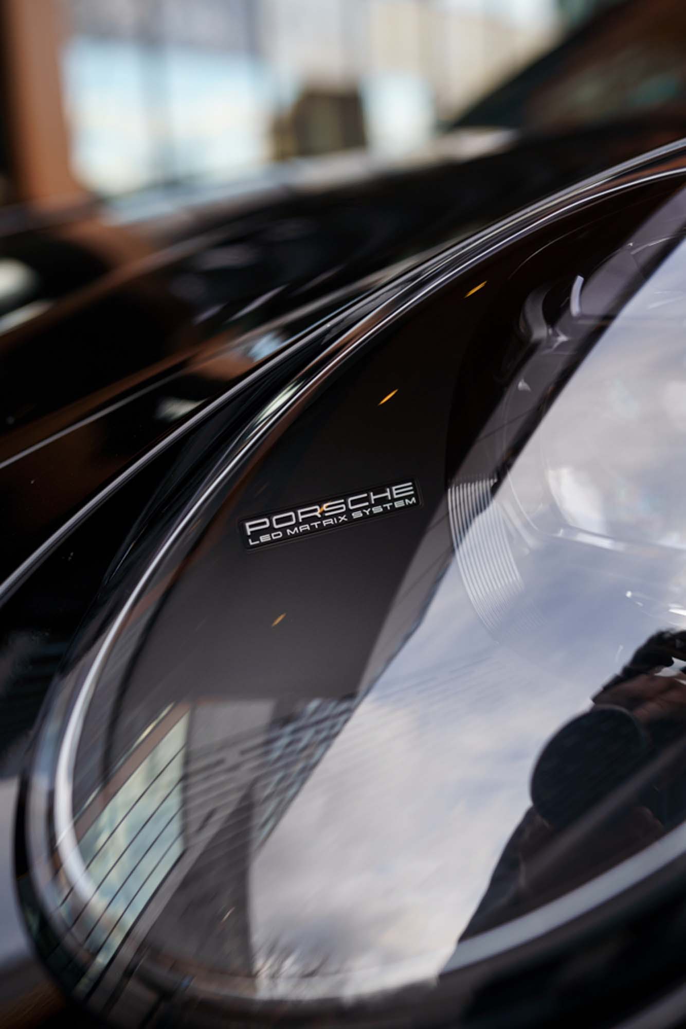 Porsche lettering on the glossy black 911 Turbo S
