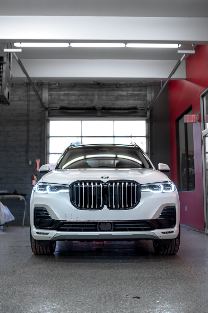 Head-on view of the white BMW X7 after PPF installation