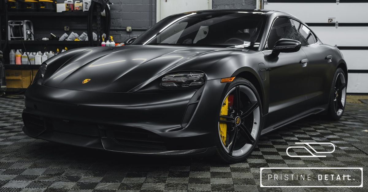 Satin black Porsche Taycan with yellow brake calipers wrapped in paint protection film