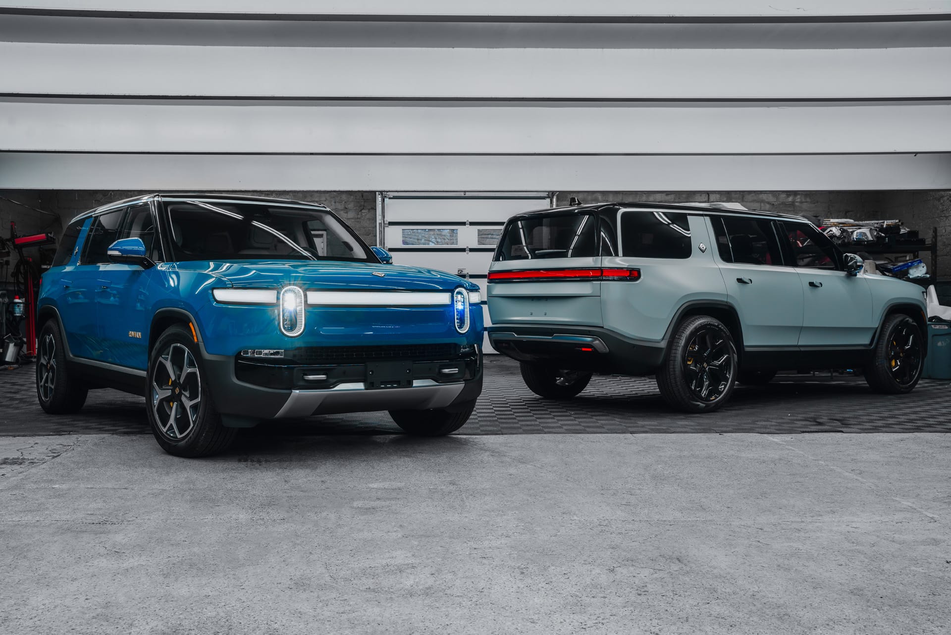 Blue and gray Rivian SUVs outside the Pristine Detail shop