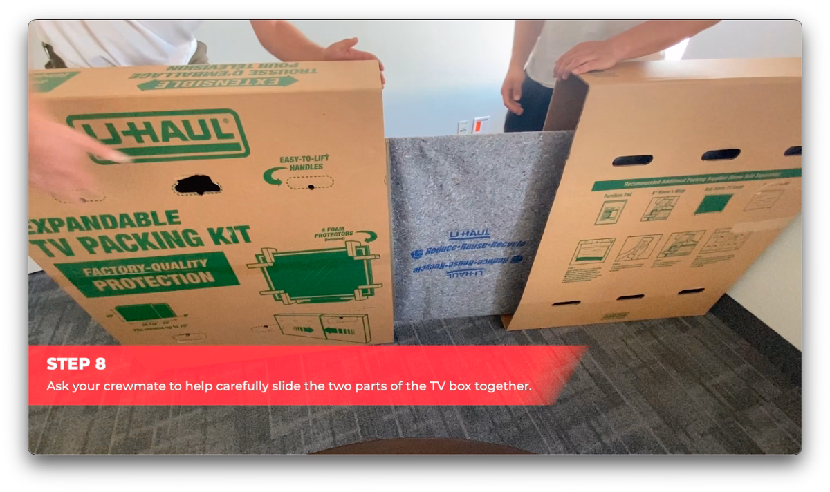 Cactus Moving workers sliding the two parts of a TV box together over a wrapped flat-screen TV.