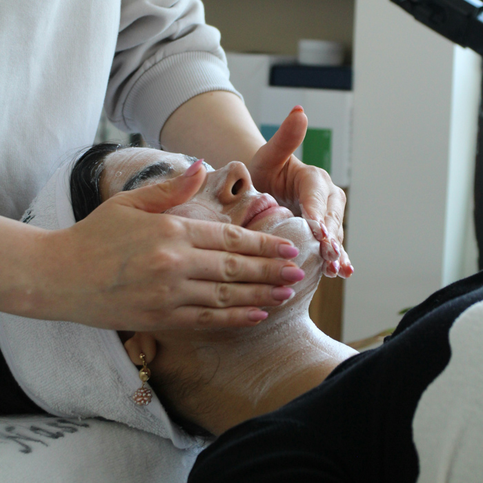 woman getting a facial treatment at a spa