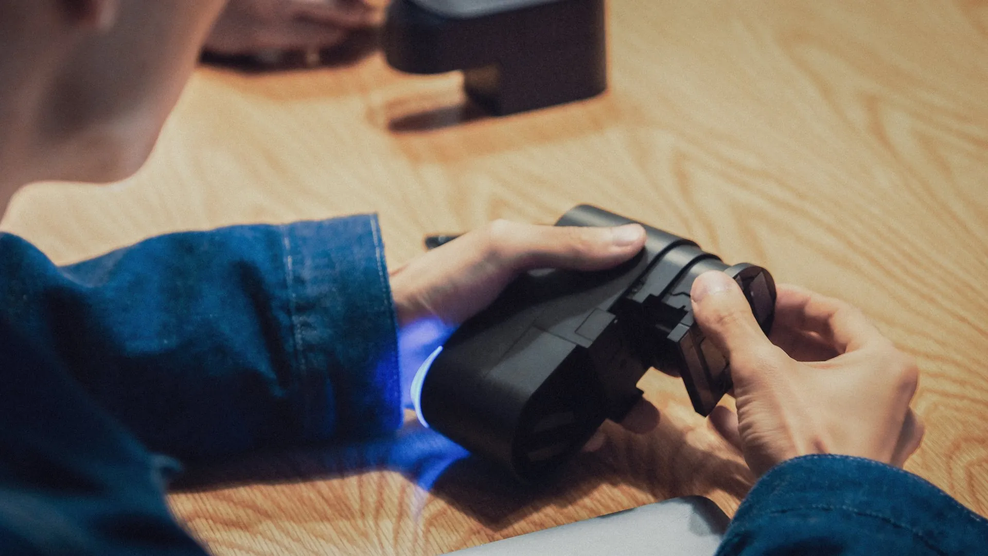 A person extending the bitlock PRO's telescope attachment while the LED's glow blue